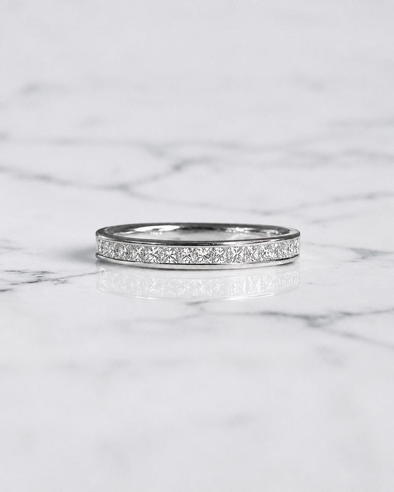 2.5mm princess cut diamond channel set wedding band with 0.40ct half set diamonds in polished white gold.