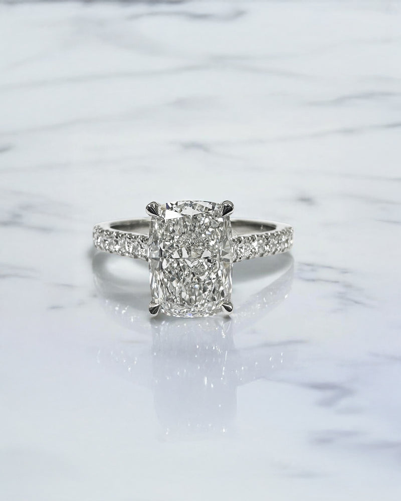 2ct elongated cushion cut lab grown diamond engagement ring with cathedral setting, hidden halo, diamond bridge and diamond shoulder band.