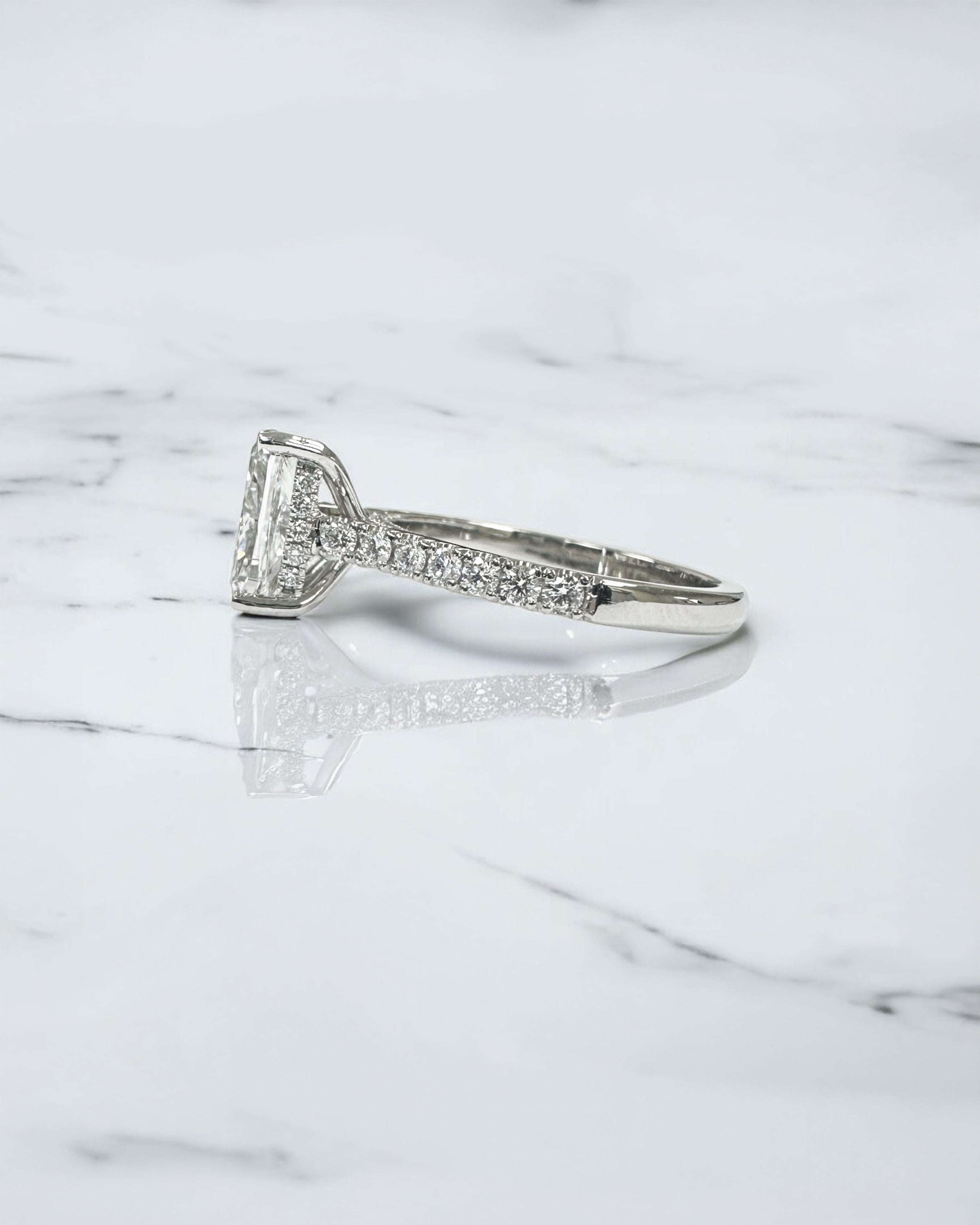 2ct elongated cushion cut lab grown diamond engagement ring with cathedral setting, hidden halo, diamond bridge and diamond shoulder band.