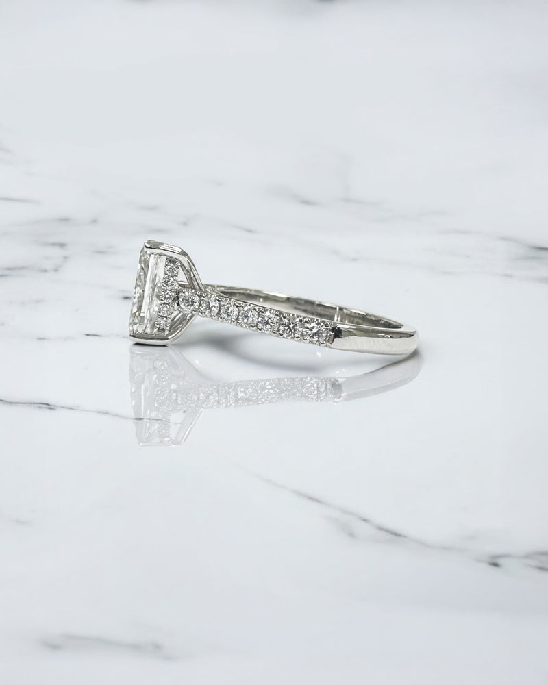 2ct elongated cushion cut lab grown diamond engagement ring with cathedral setting, hidden halo, diamond bridge and diamond shoulder band.