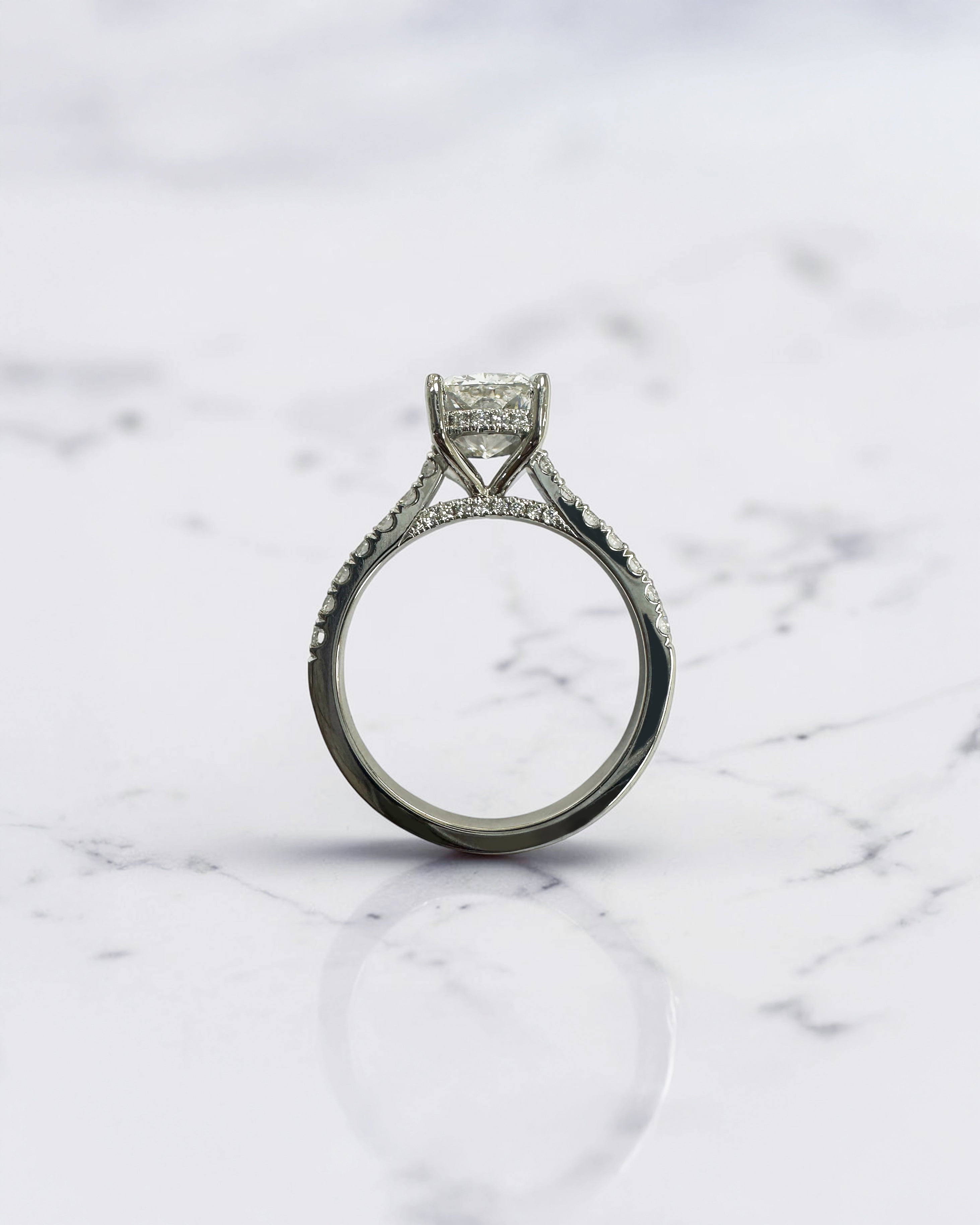 2ct elongated cushion cut lab grown diamond engagement ring with cathedral setting, hidden halo, diamond bridge and diamond shoulder band.