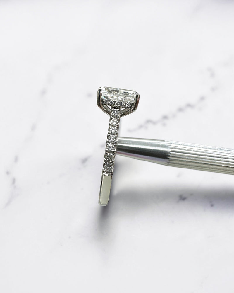 2ct elongated cushion cut lab grown diamond engagement ring with cathedral setting, hidden halo, diamond bridge and diamond shoulder band.
