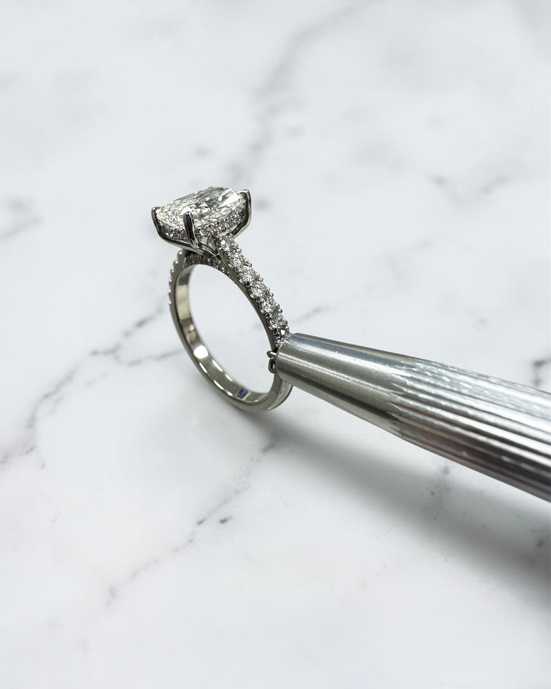 2ct elongated cushion cut lab grown diamond engagement ring with cathedral setting, hidden halo, diamond bridge and diamond shoulder band.