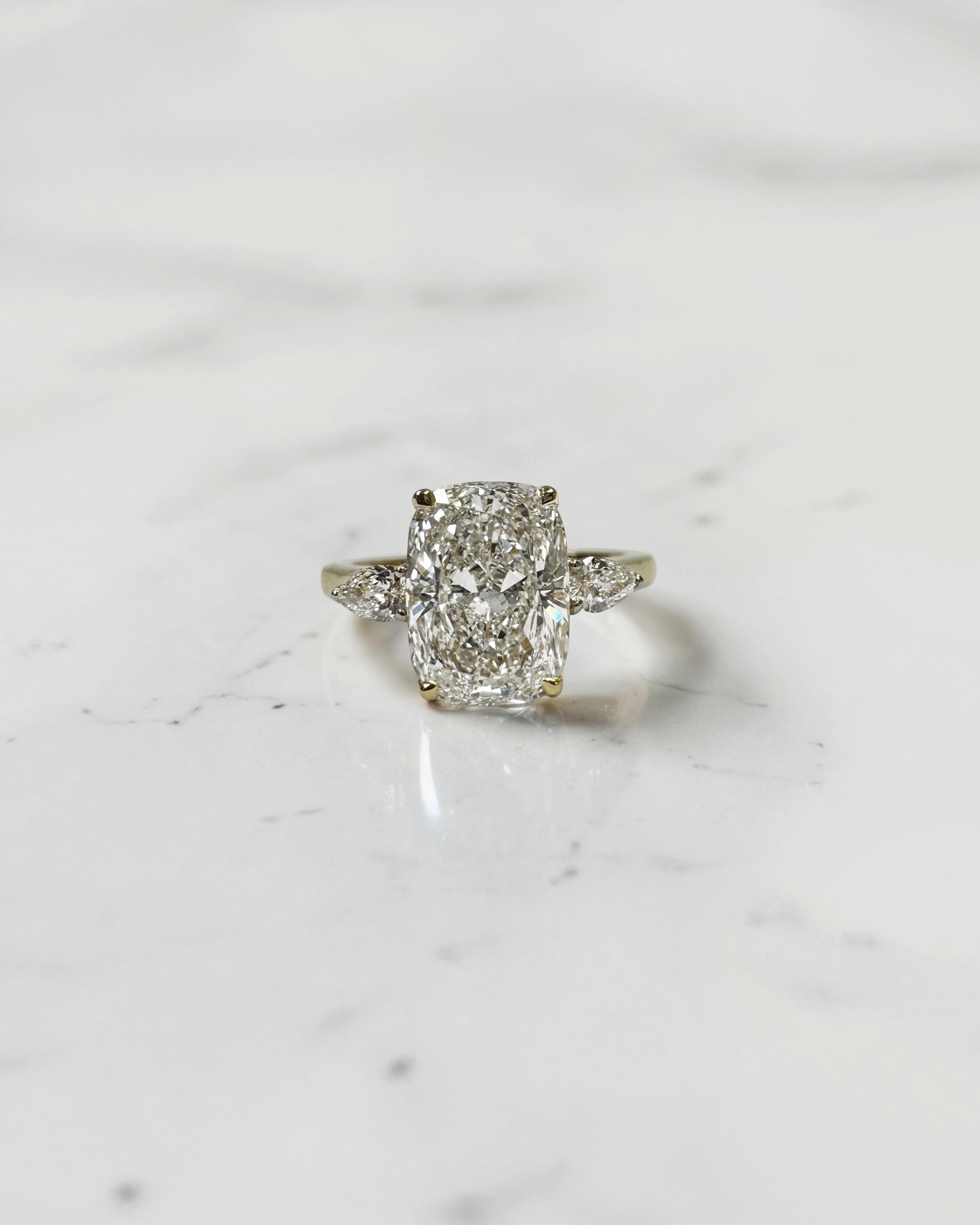 elongated cushion cut diamond trilogy ring 2ct centre with pear diamond side stones 18kt yellow gold engagement ring