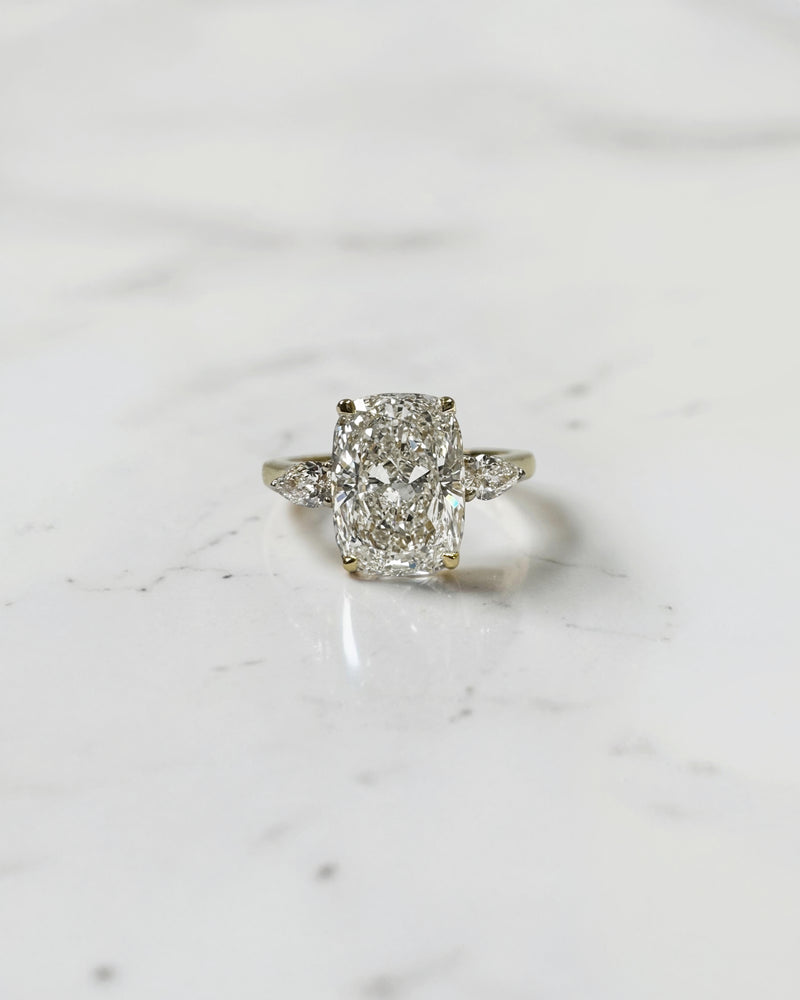 elongated cushion cut diamond trilogy ring 2ct centre with pear diamond side stones 18kt yellow gold engagement ring