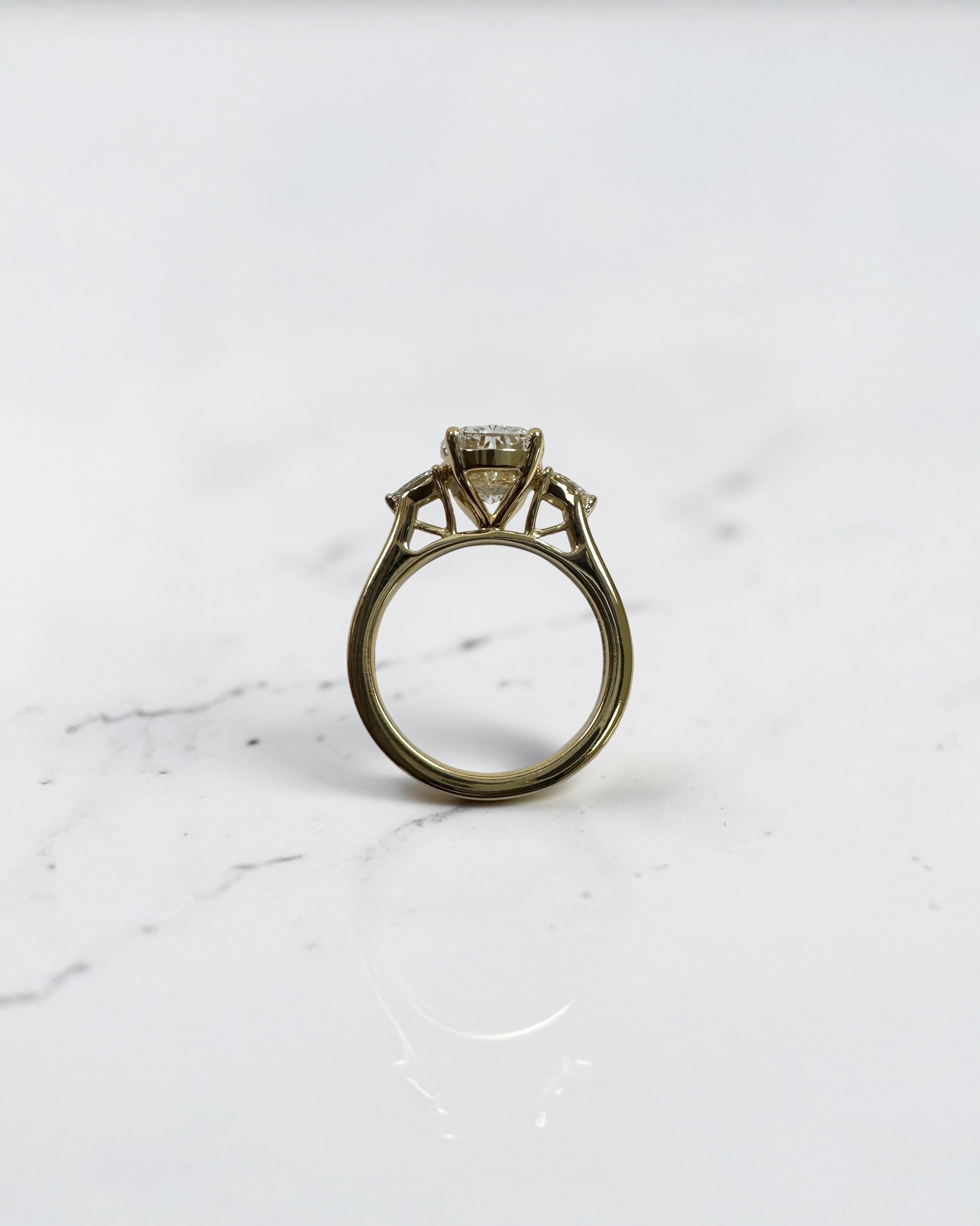 elongated cushion cut diamond trilogy ring 2ct centre with pear diamond side stones 18kt yellow gold engagement ring