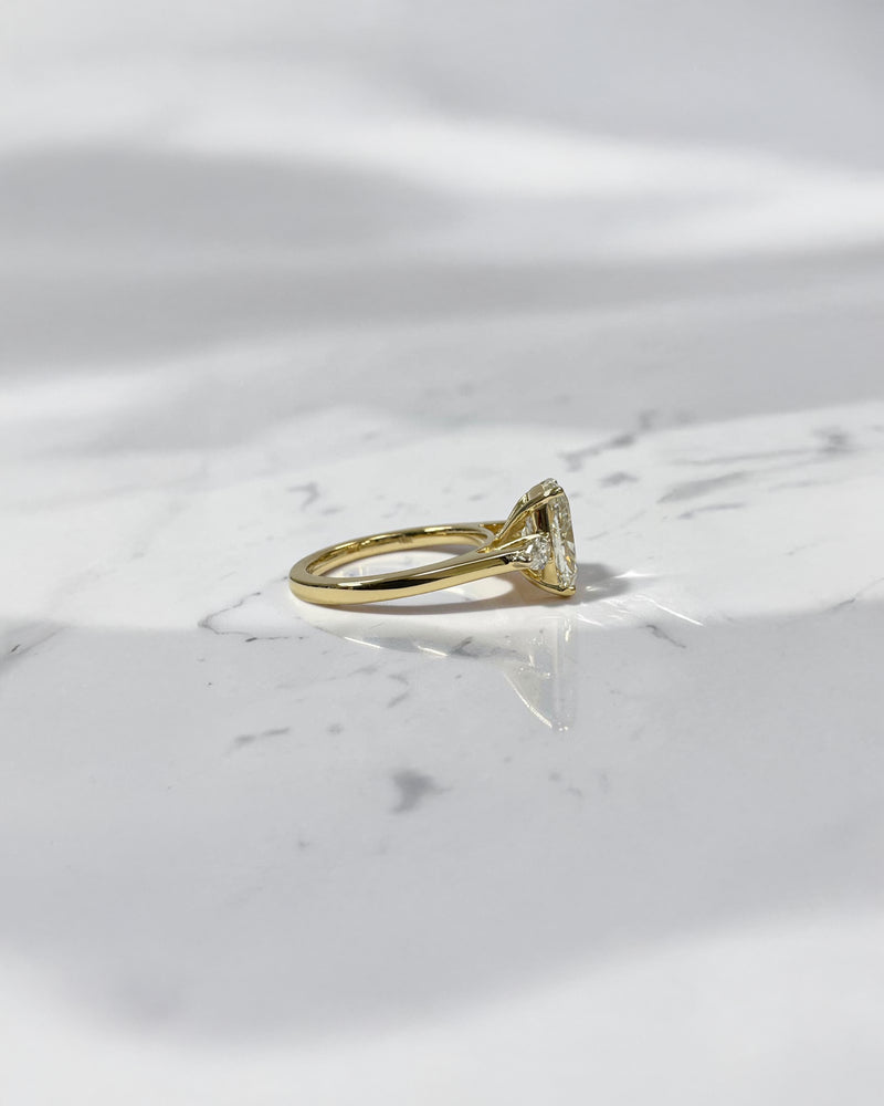 elongated cushion cut diamond trilogy ring 2ct centre with pear diamond side stones 18kt yellow gold engagement ring