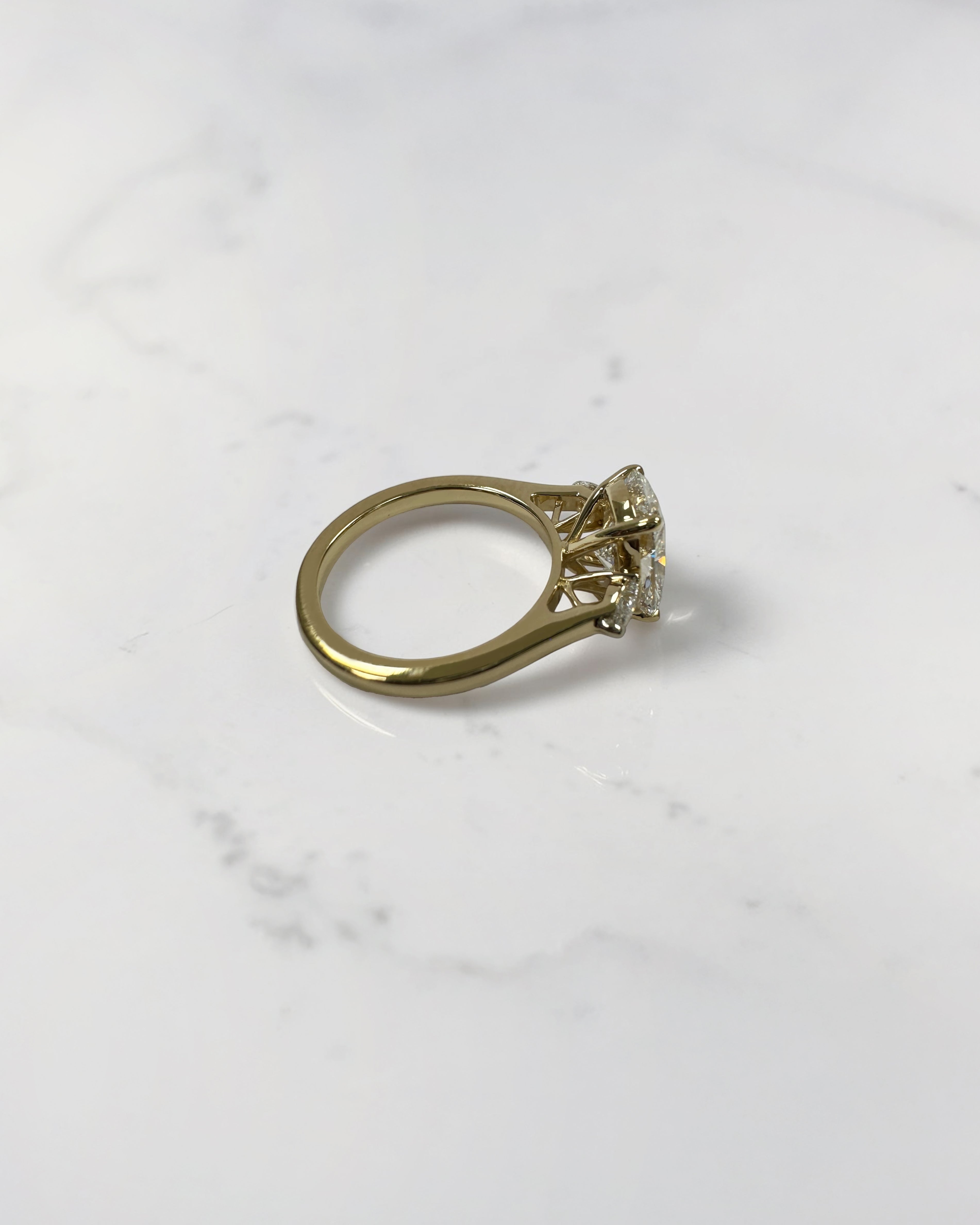 elongated cushion cut diamond trilogy ring 2ct centre with pear diamond side stones 18kt yellow gold engagement ring
