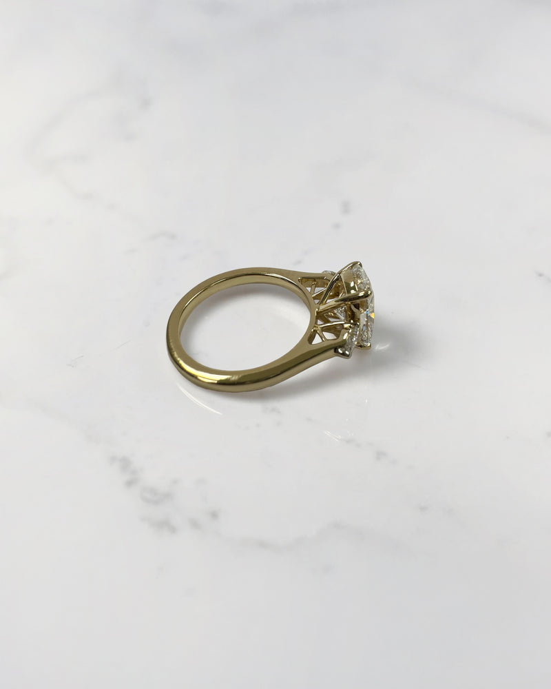 elongated cushion cut diamond trilogy ring 2ct centre with pear diamond side stones 18kt yellow gold engagement ring