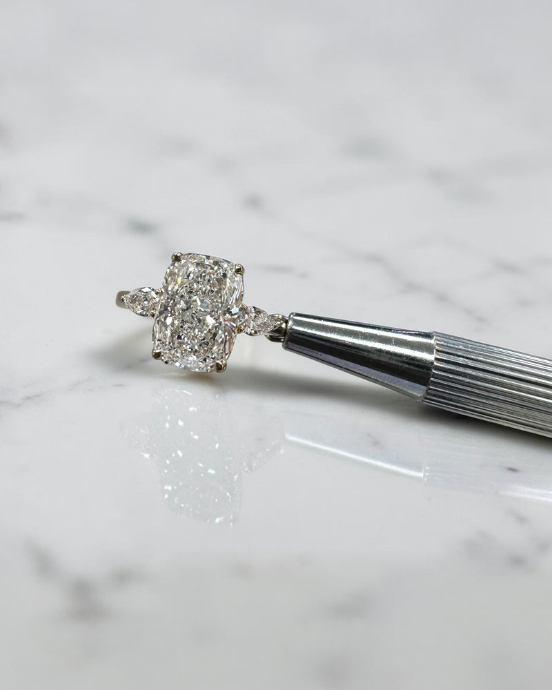 elongated cushion cut diamond trilogy ring 2ct centre with pear diamond side stones 18kt yellow gold engagement ring