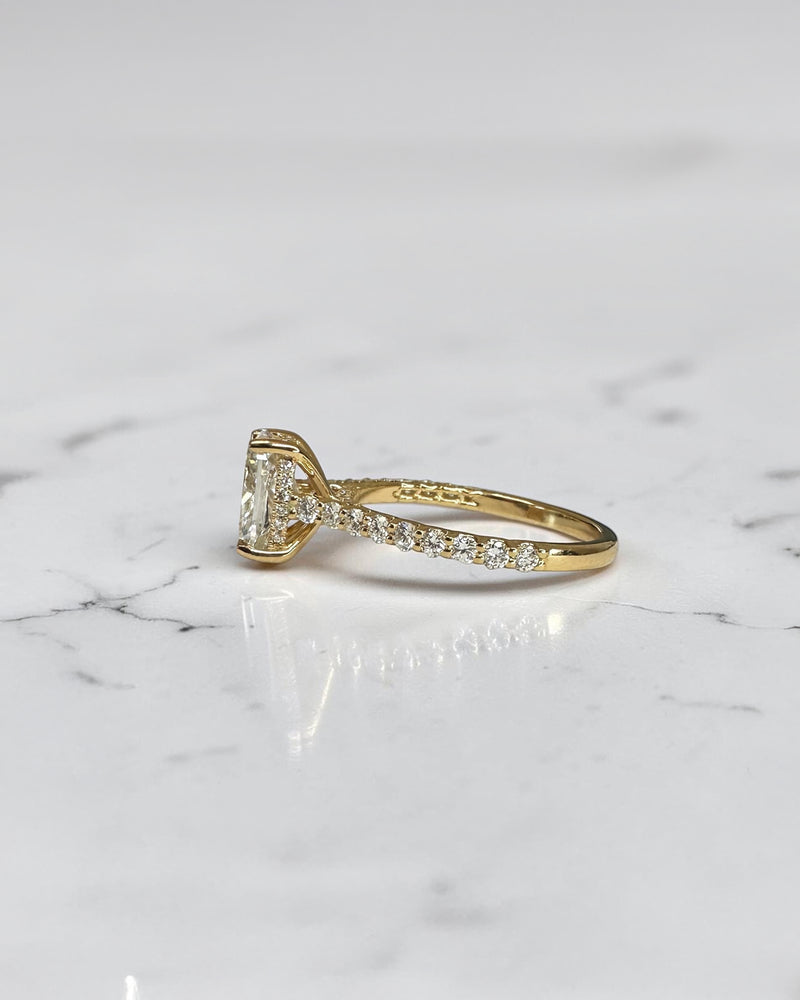 2ct elongated cushion cut lab grown diamond engagement ring with U prong cathedral setting and diamond shoulders in yellow gold