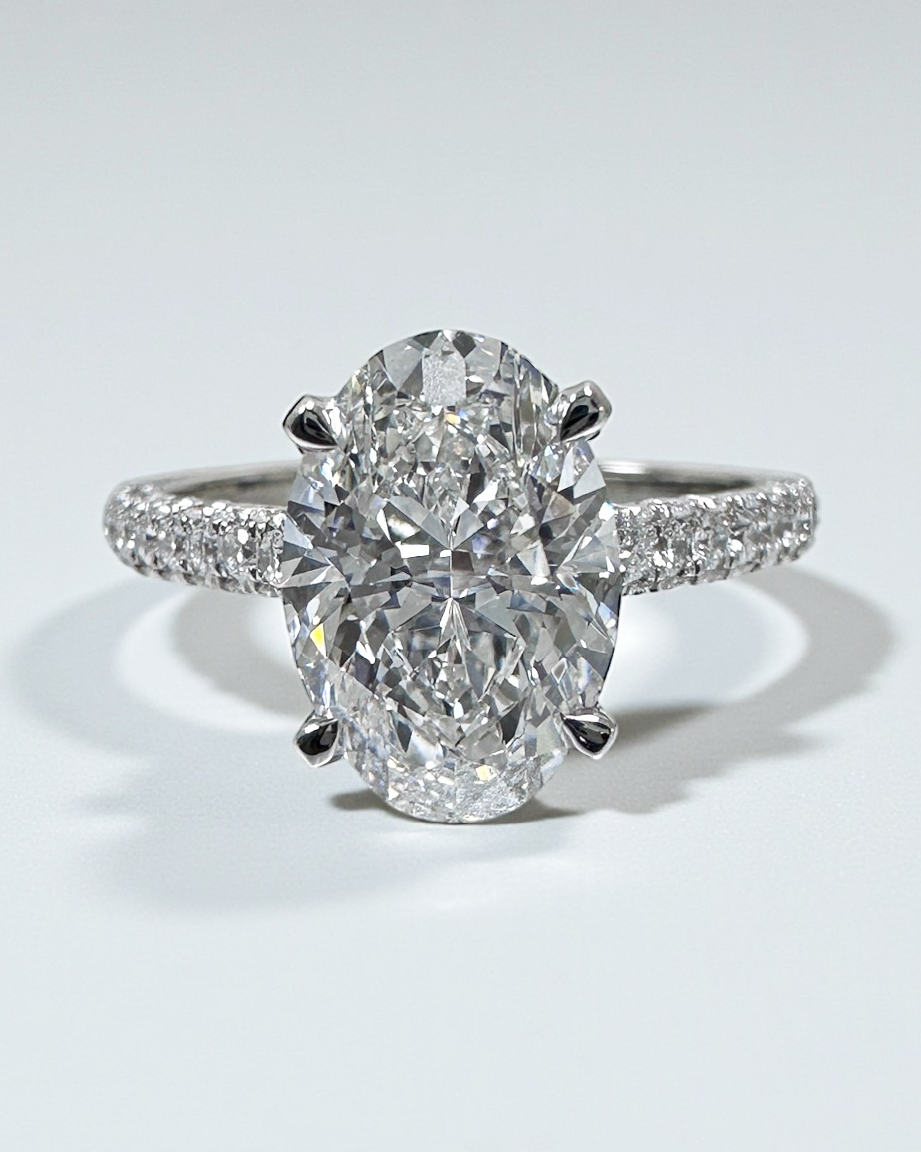 2ct oval cut lab grown diamond set in a cathedral 3d diamond band engagement ring, platinum 18kt gold, hidden halo, made in London, Layla Diamonds