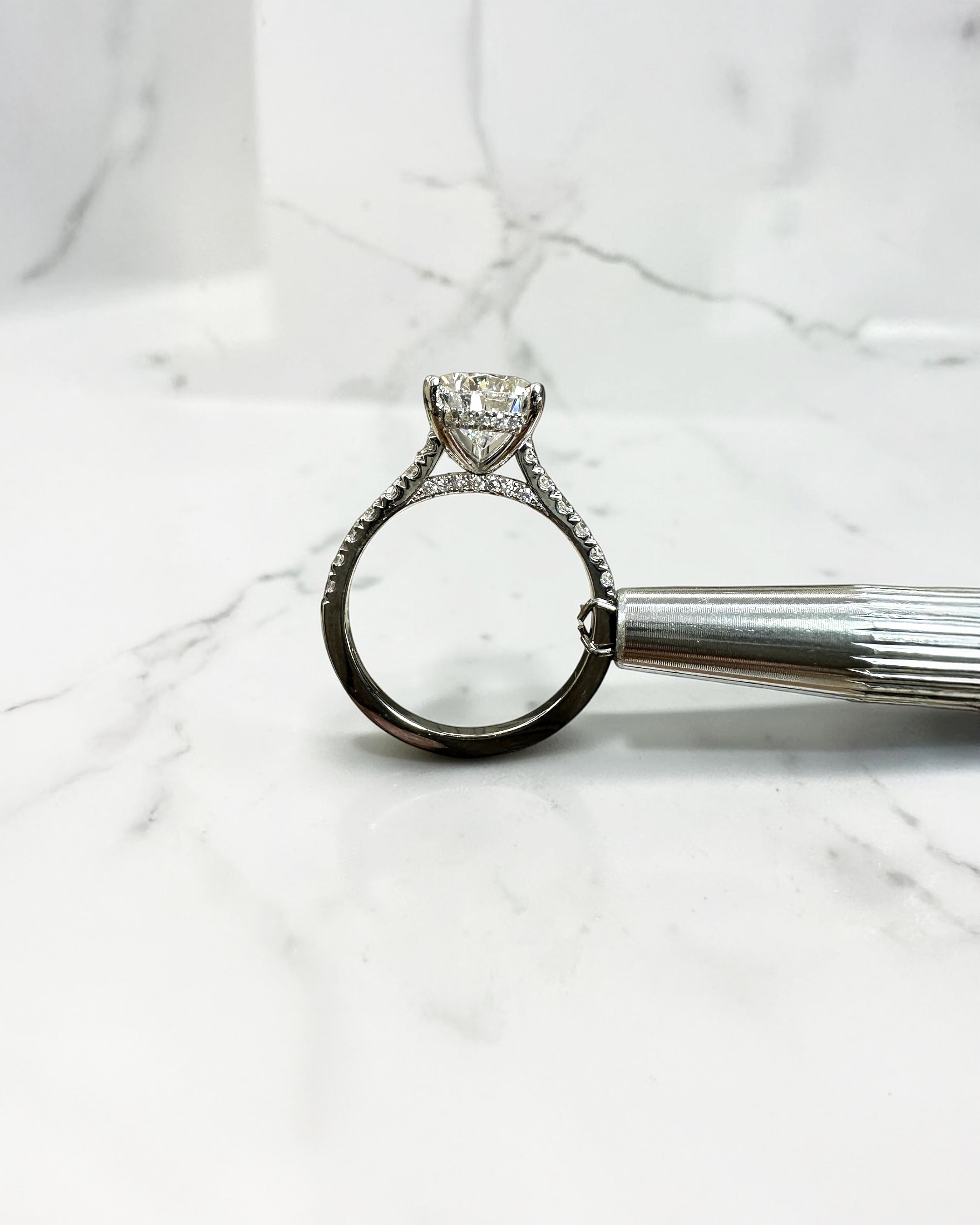 2ct pear cut lab grown diamond engagement ring with cathedral setting, diamond shoulder band, hidden halo and diamond bridge, handcrafted in platinum by Layla Diamonds.