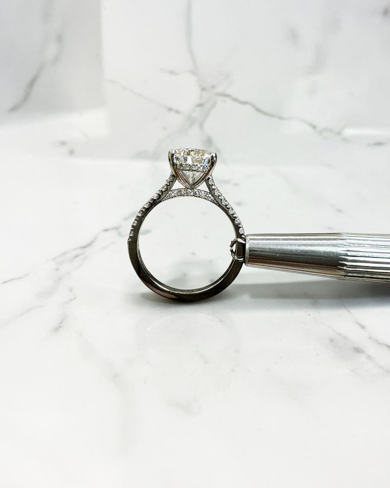 2ct pear cut lab grown diamond engagement ring with cathedral setting, diamond shoulder band, hidden halo and diamond bridge, handcrafted in platinum by Layla Diamonds.
