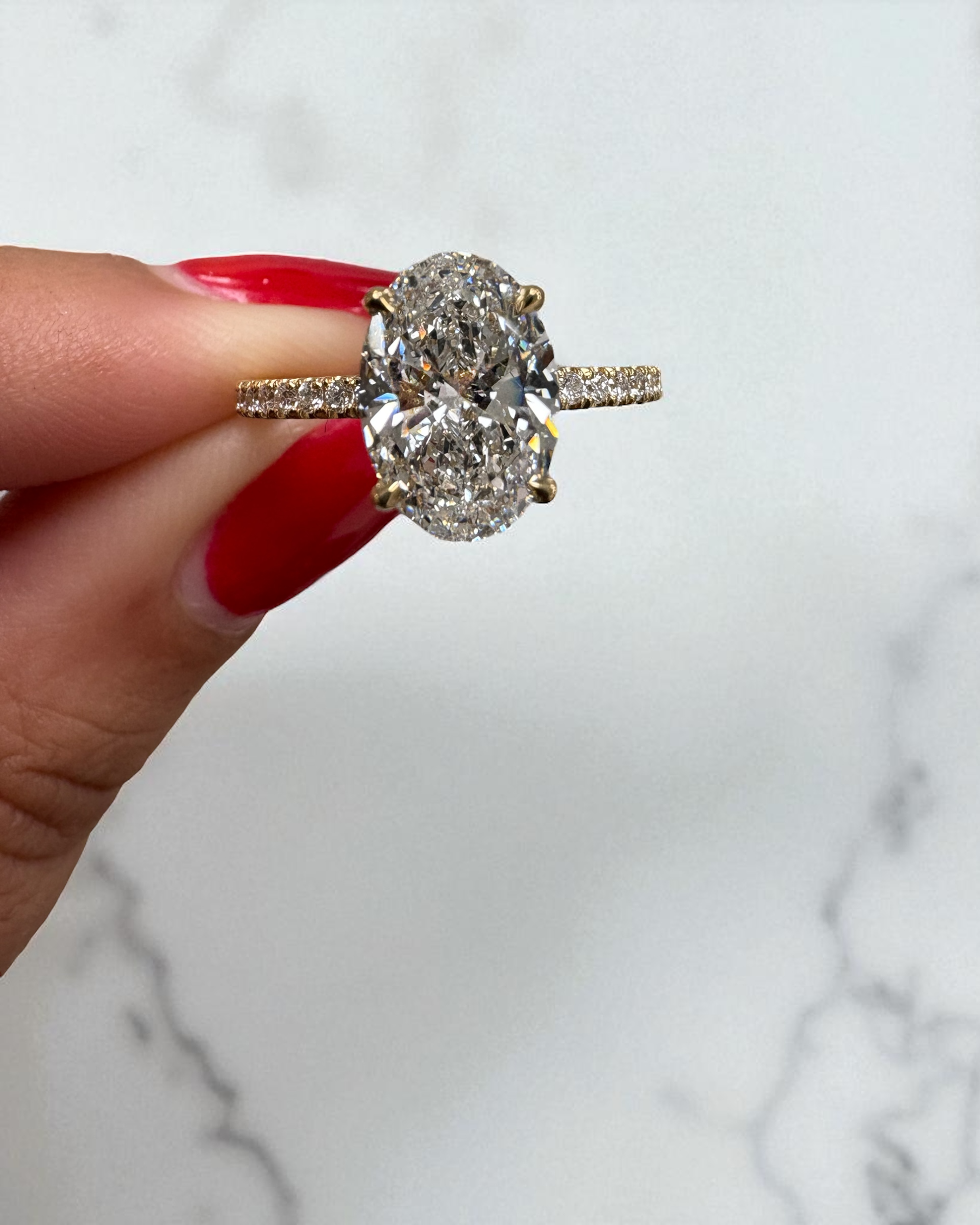 2ct oval cut lab grown diamond hidden halo diamond shoulders 18kt yellow gold 