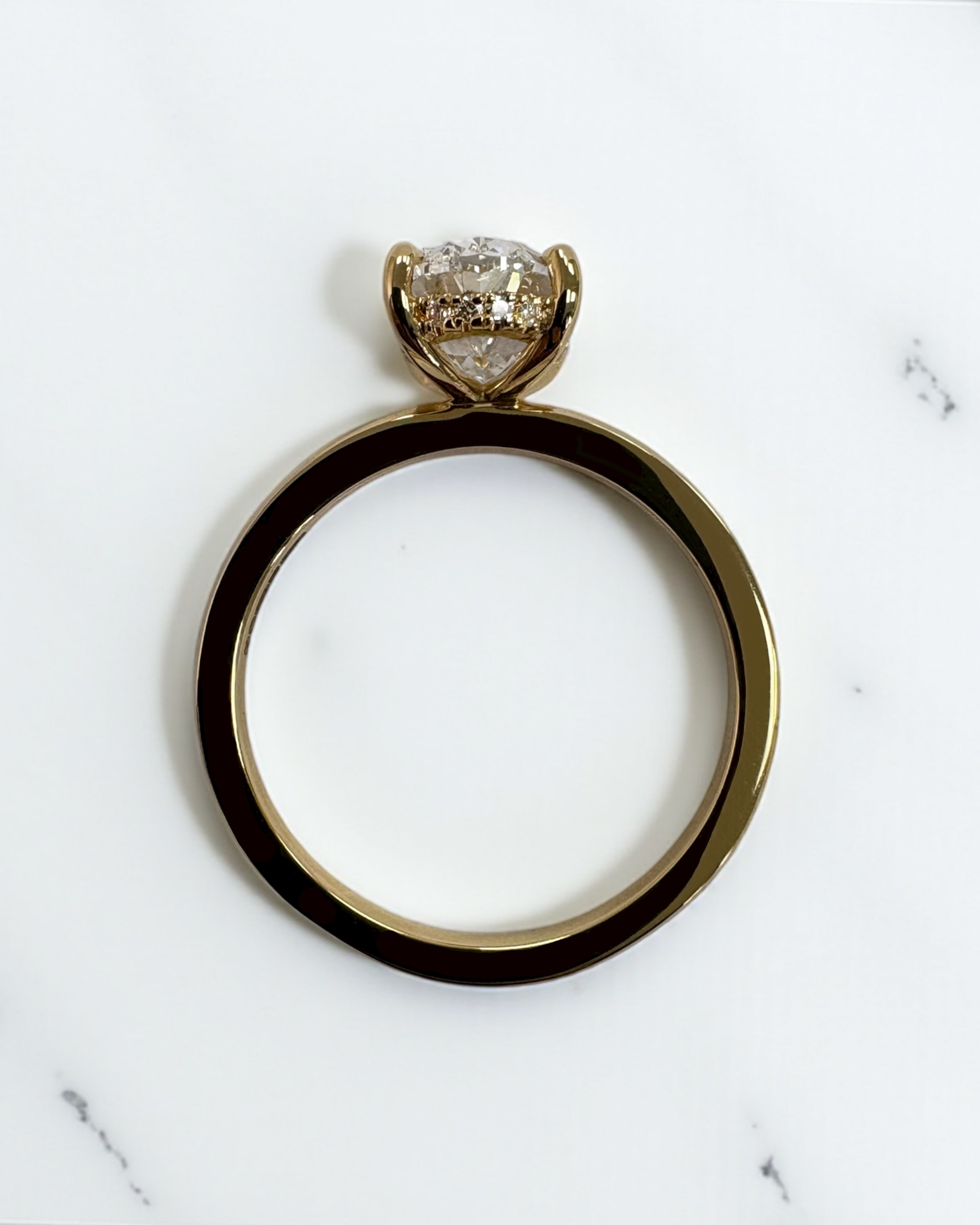 2ct oval cut lab grown diamond floating head engagement ring with hidden halo on a plain soft court band in 18kt yellow gold 