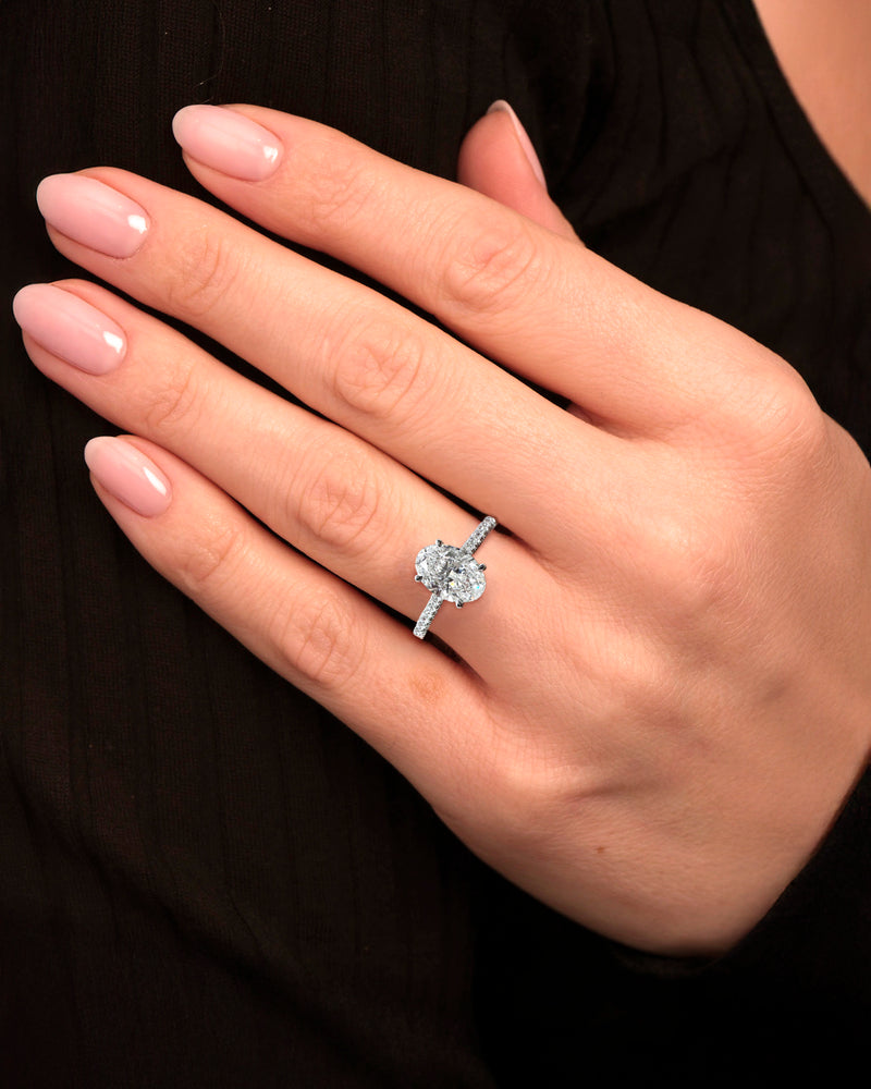 2ct oval cut lab grown diamond set in a cathedral 3d diamond band engagement ring, platinum 18kt gold, hidden halo, made in London, Layla Diamonds on hand