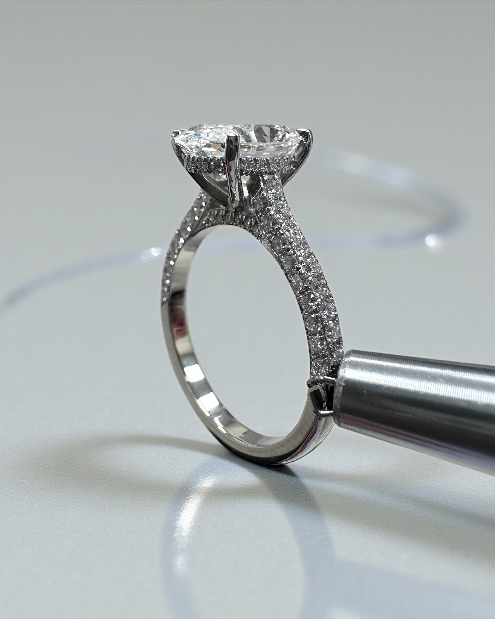 2ct oval cut lab grown diamond set in a cathedral 3d diamond band engagement ring, platinum 18kt gold, hidden halo, made in London, Layla Diamonds