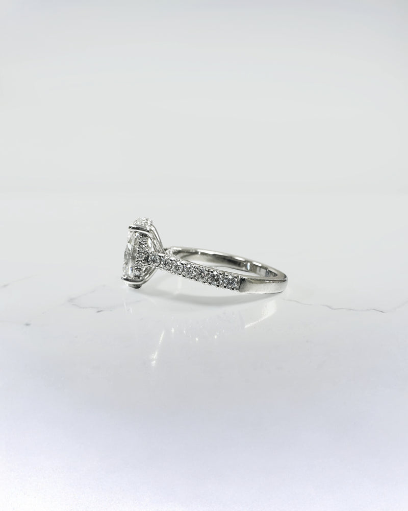 2ct oval cut lab grown diamond cathedral engagement ring with hidden halo, diamond bridge and pavé diamond shoulder band in platinum
