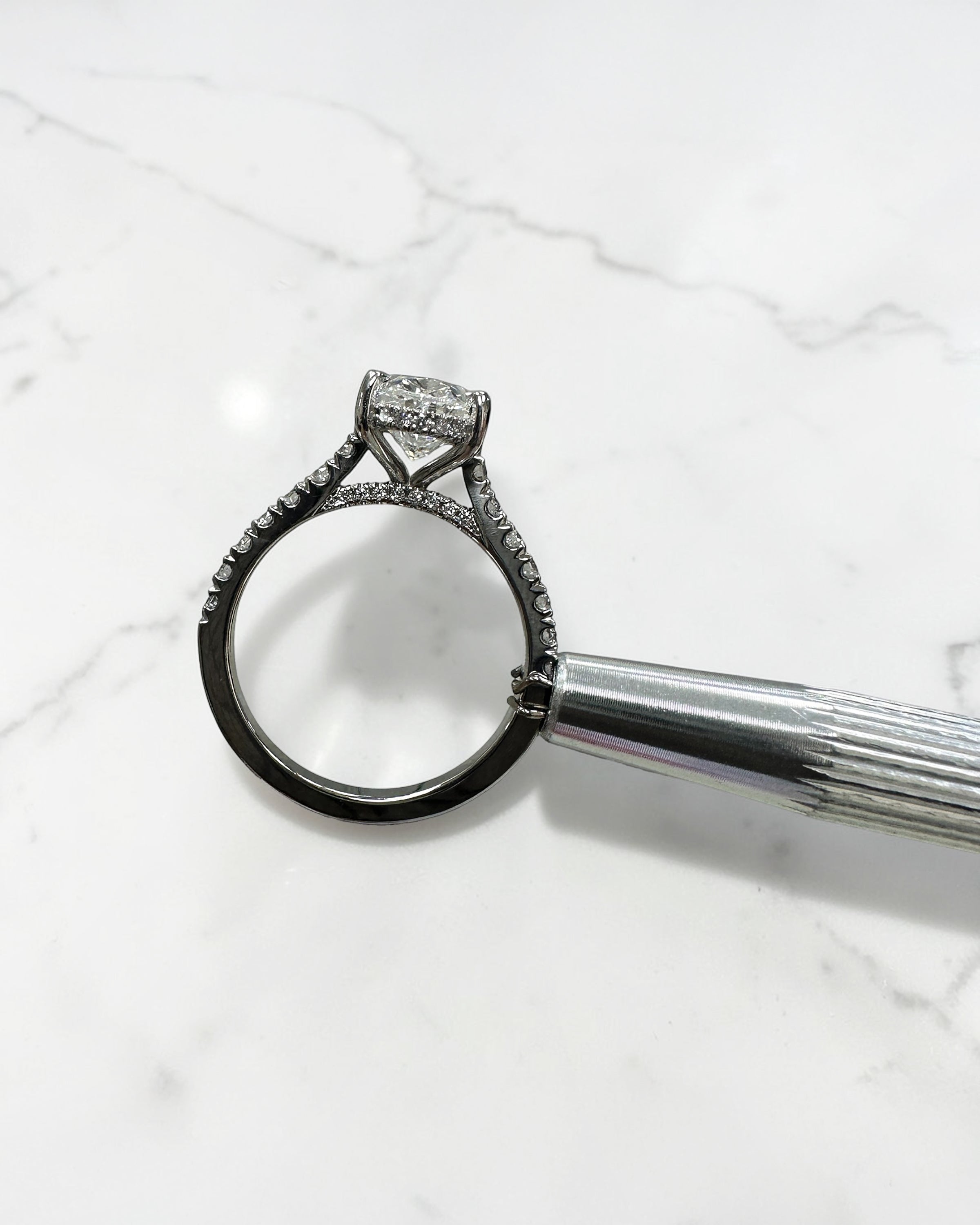 2ct oval cut lab grown diamond cathedral engagement ring with hidden halo, diamond bridge and pavé diamond shoulder band in platinum