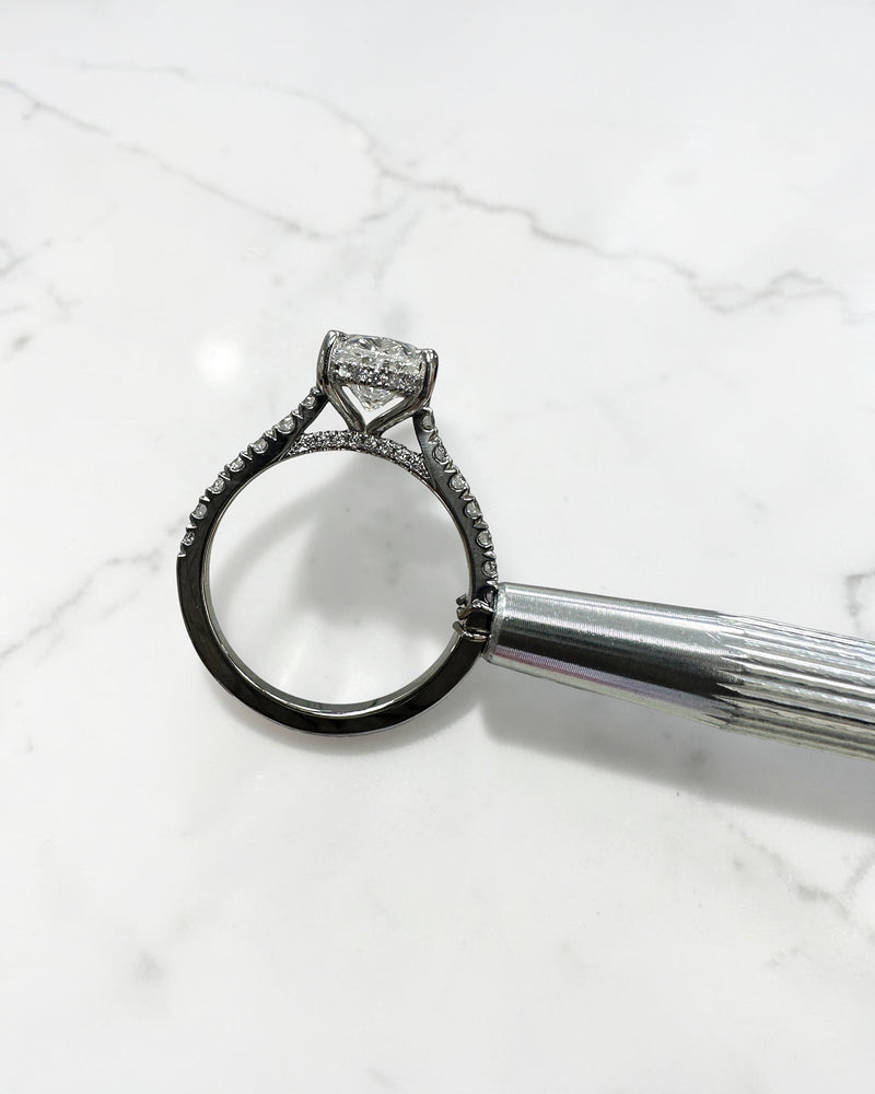 2ct oval cut lab grown diamond cathedral engagement ring with hidden halo, diamond bridge and pavé diamond shoulder band in platinum
