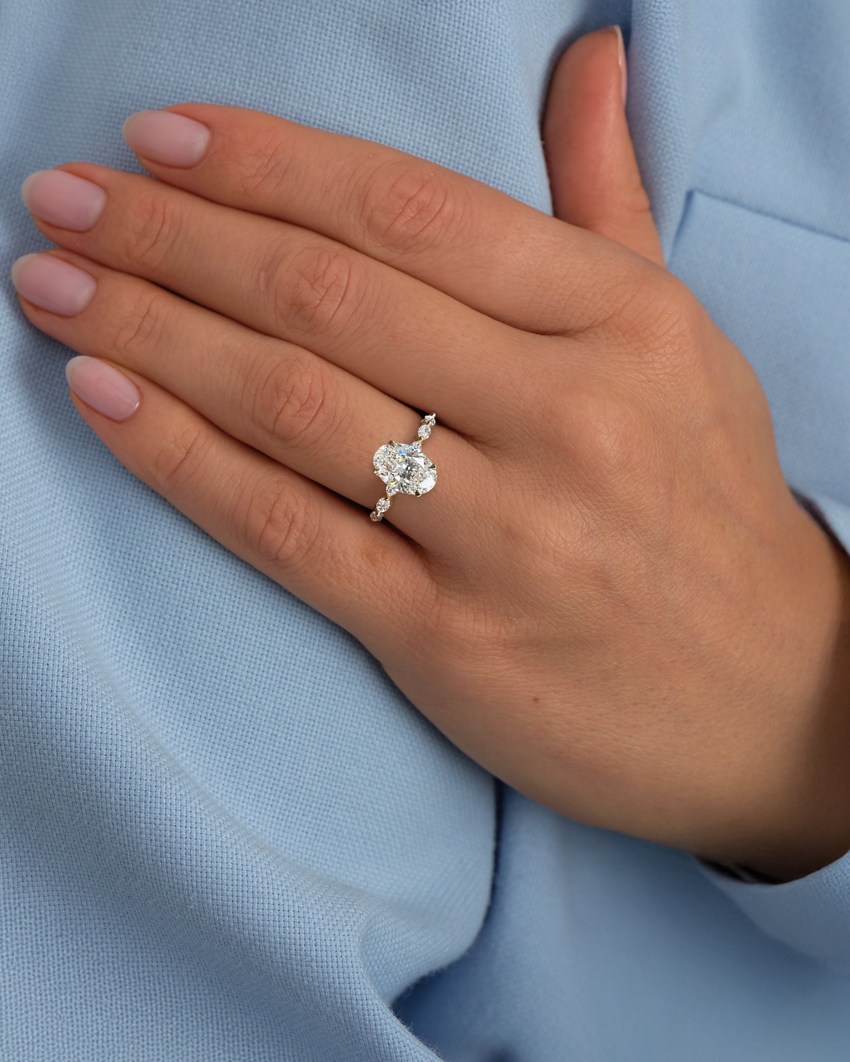 2ct Oval Cut Lab Grown Diamond Engagement Ring with Marquise Cut Diamond Band & floating Head, 18kt yellow gold on hand