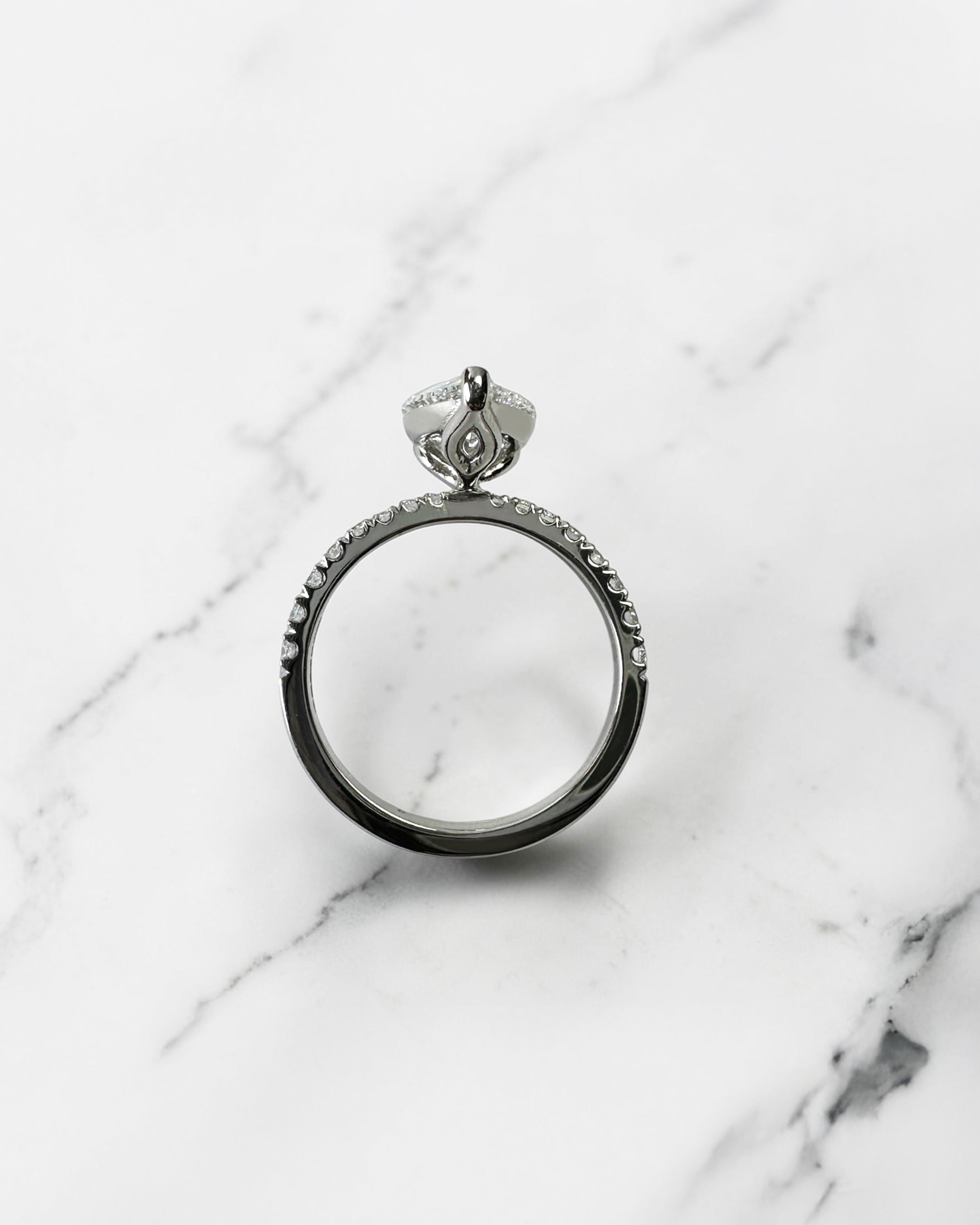 2ct pear cut lab grown diamond engagement ring with tapered diamond shoulder band and lotus three prong setting in platinum, handmade in London.
