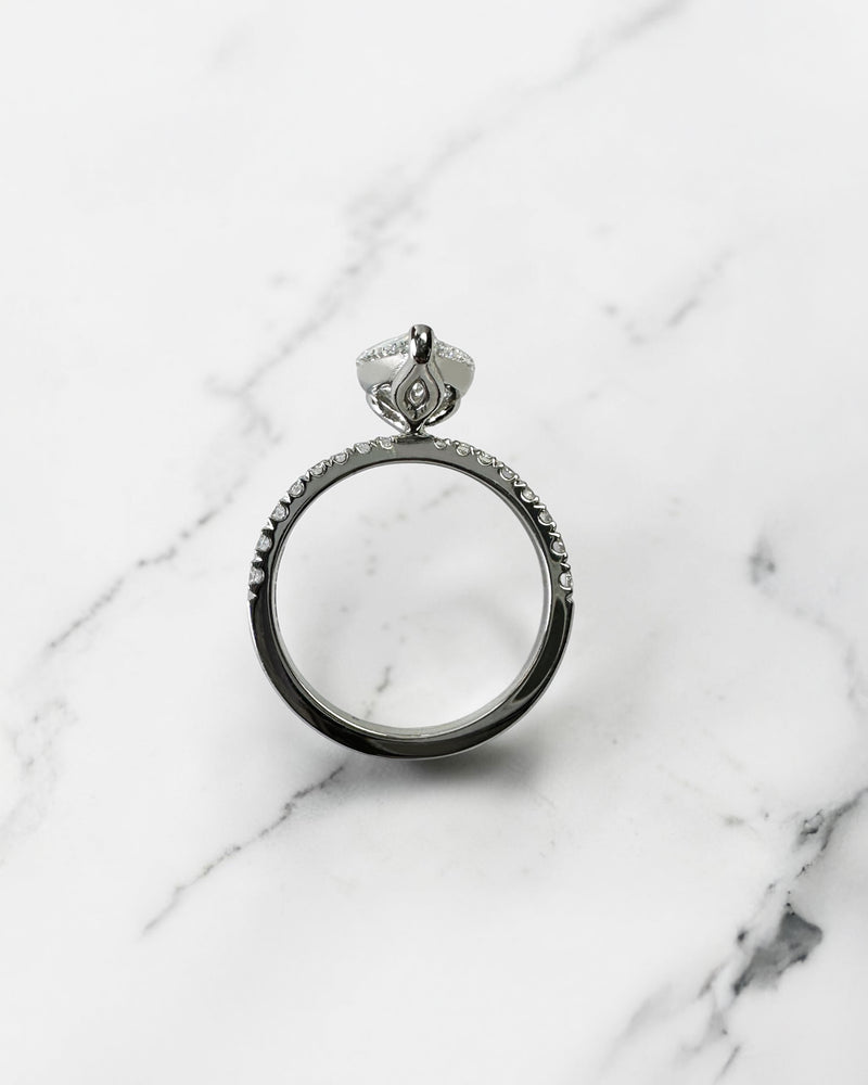2ct pear cut lab grown diamond engagement ring with tapered diamond shoulder band and lotus three prong setting in platinum, handmade in London.
