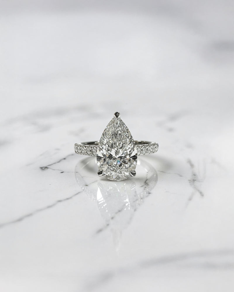 2ct pear cut lab grown diamond engagement ring with cathedral setting, diamond shoulder band, hidden halo and diamond bridge, handcrafted in platinum by Layla Diamonds.