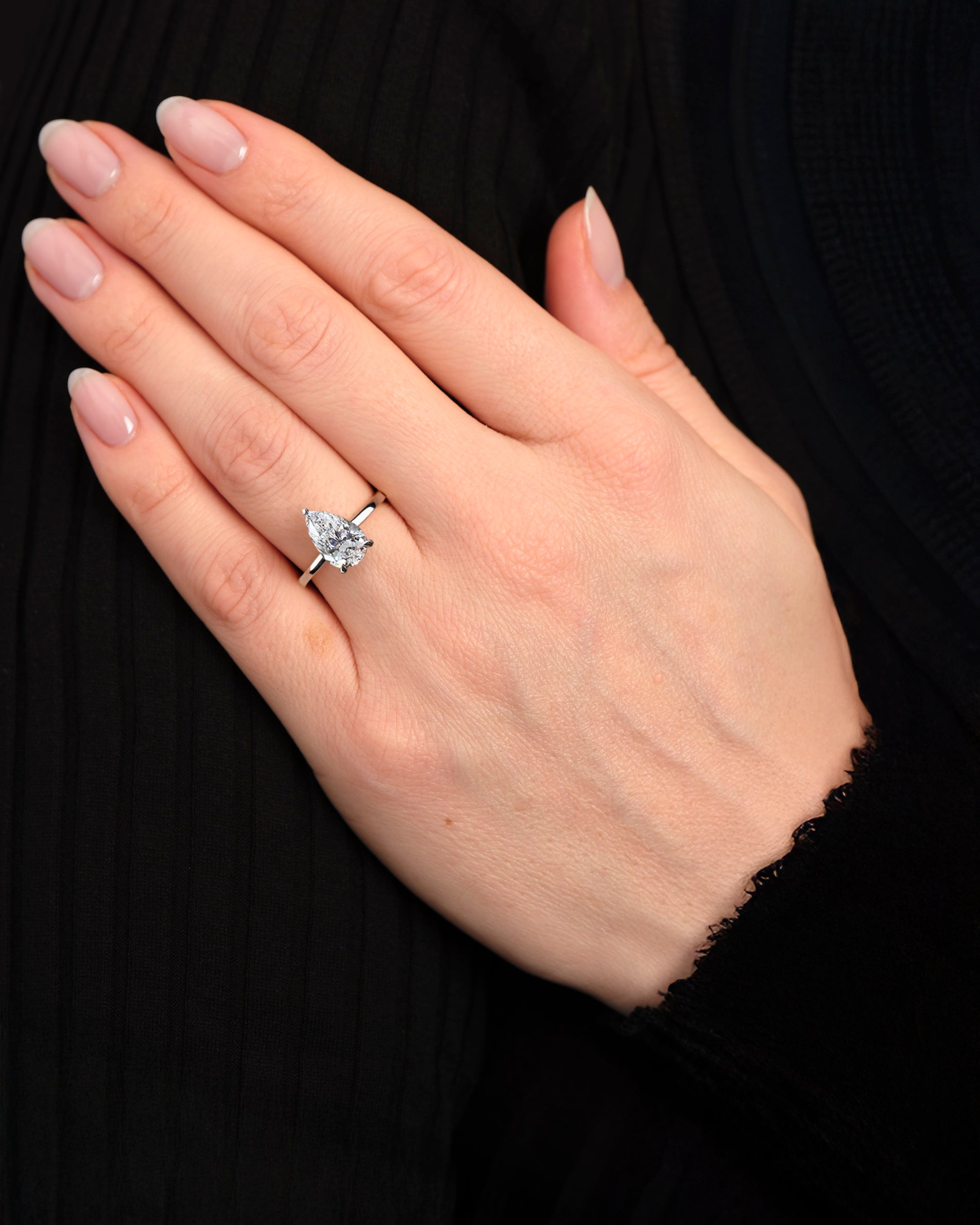 2ct pear cut lab grown diamond cathedral solitaire engagement ring on hand size