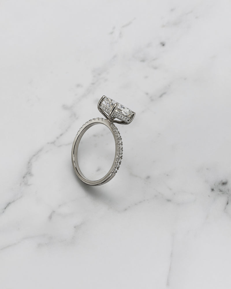 Lab grown 2ct radiant cut diamond engagement ring with hidden halo and pavé diamond shoulders platinum 18kt white gold