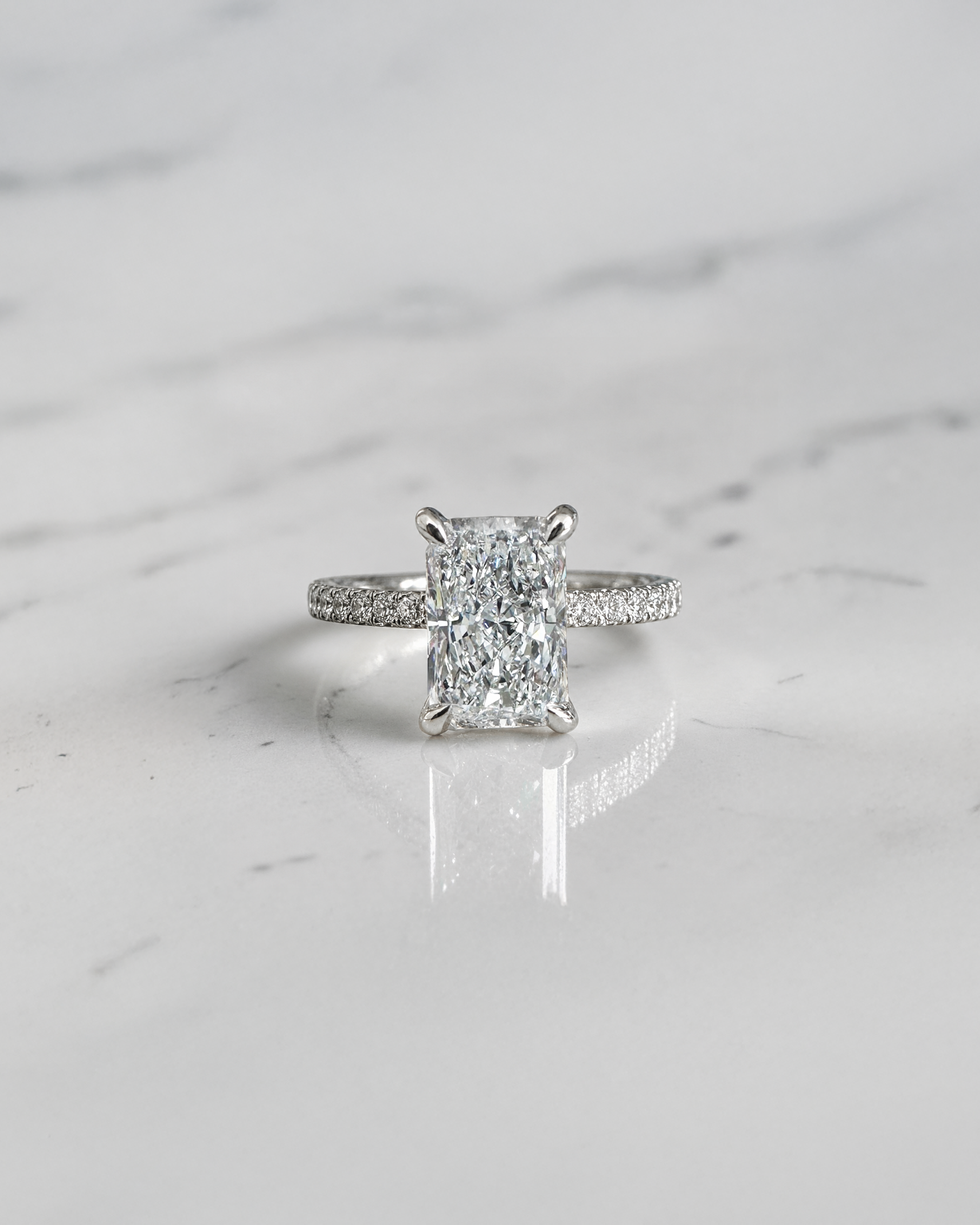 2ct radiant cut lab grown diamond engagement ring with open diamond set prongs and pavé diamond band in white gold, total 2.34ct
