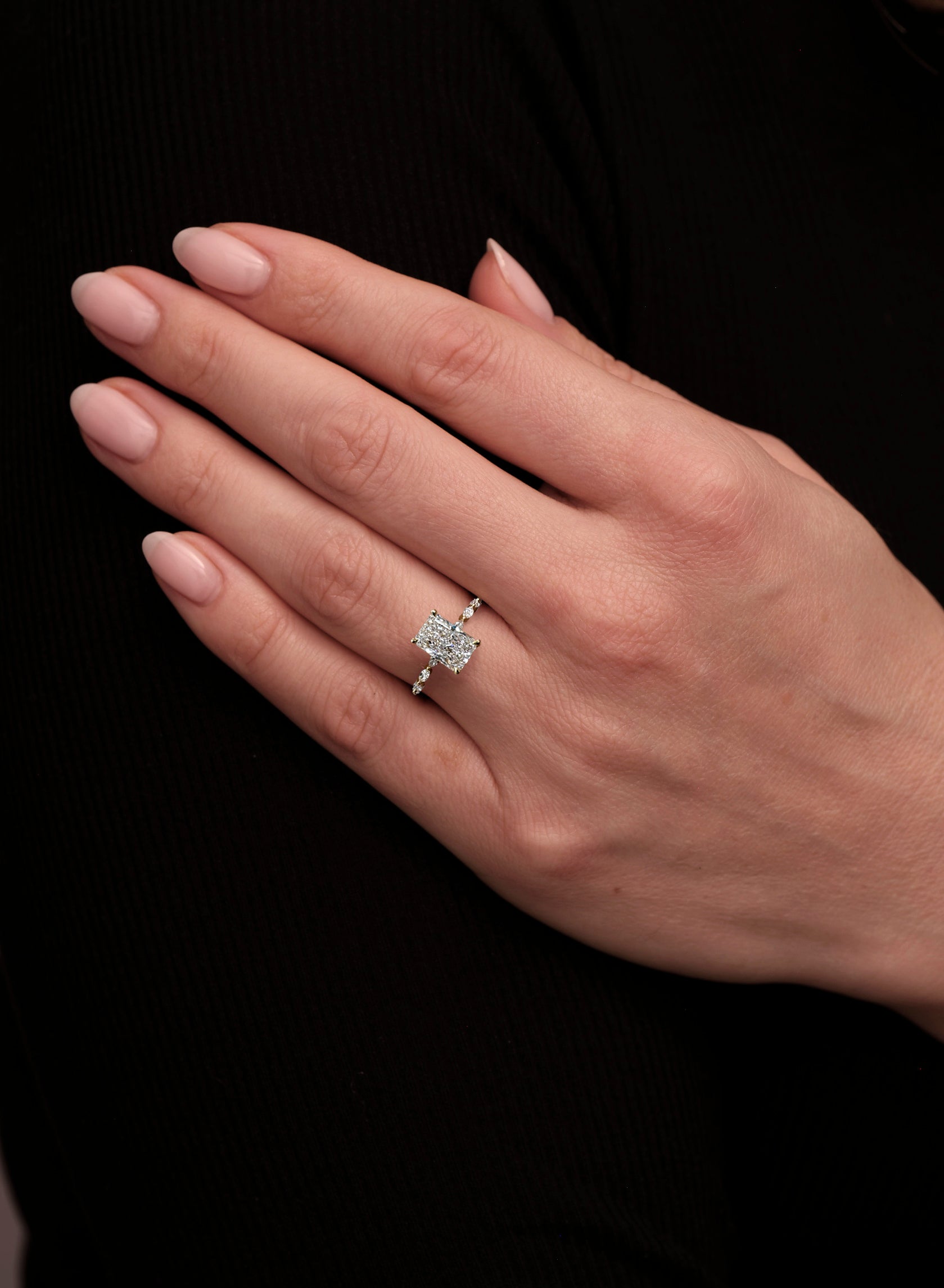 2ct Lab Grown Radiant Cut Diamond Engagement Ring with Marquise Cut Diamond Band on hand