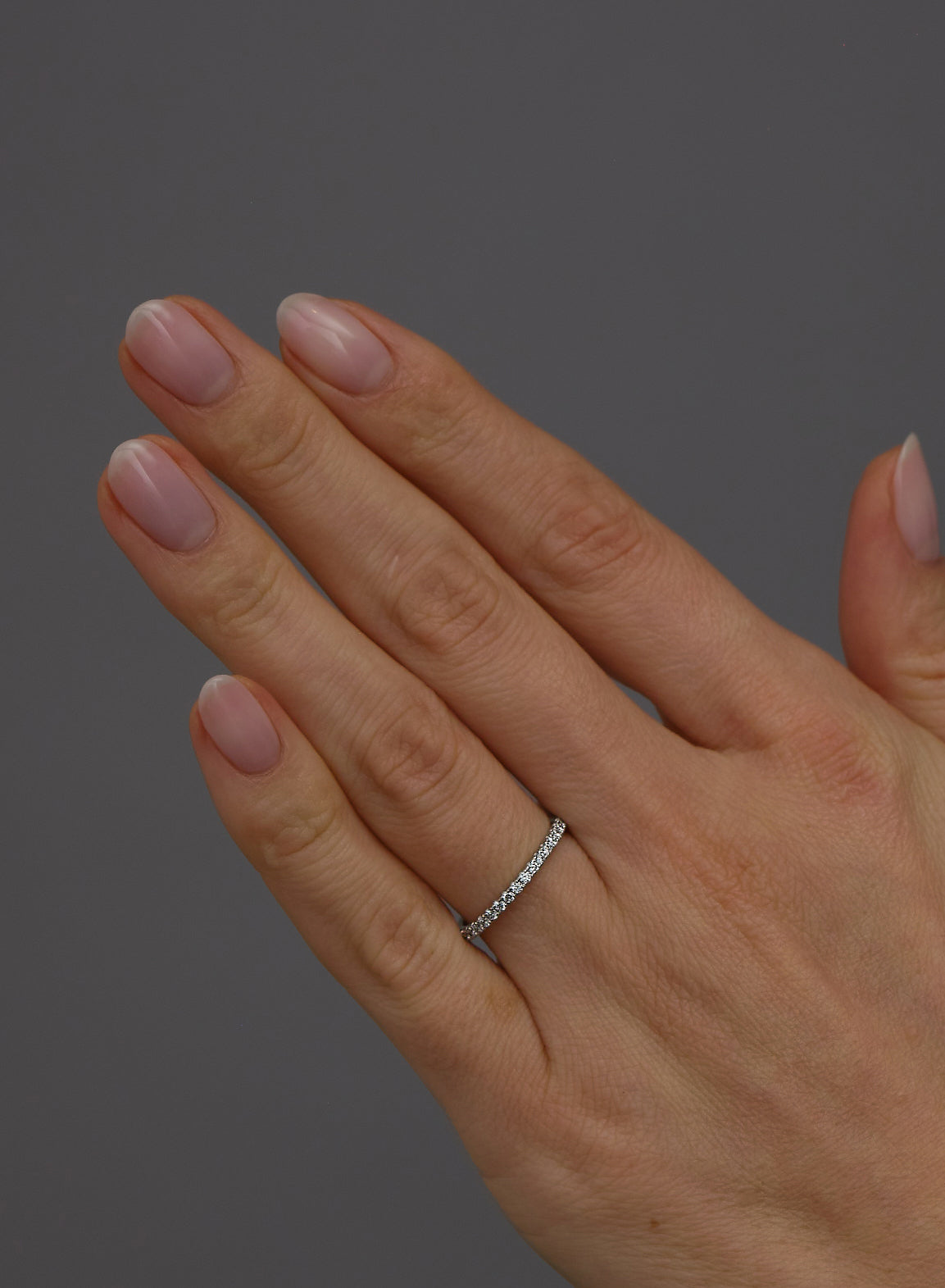 Close-up detail of the round diamonds on this 2mm women's diamond engagement band.