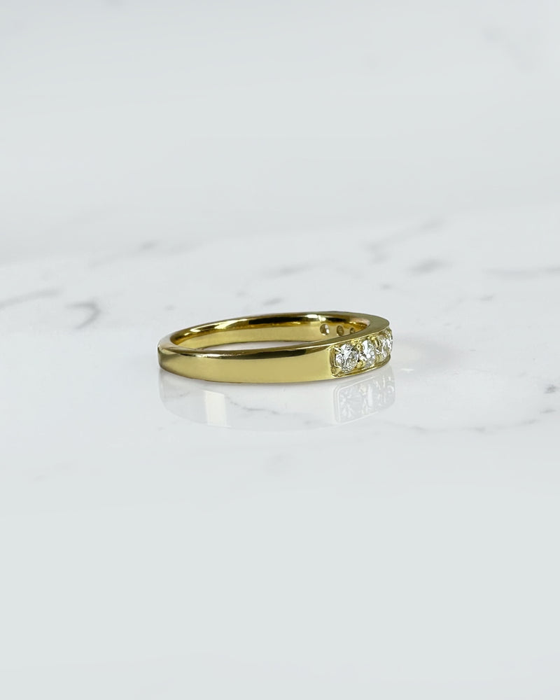 3.3mm yellow gold channel set round diamond wedding band with 0.45ct diamonds, available in lab grown or natural diamonds.