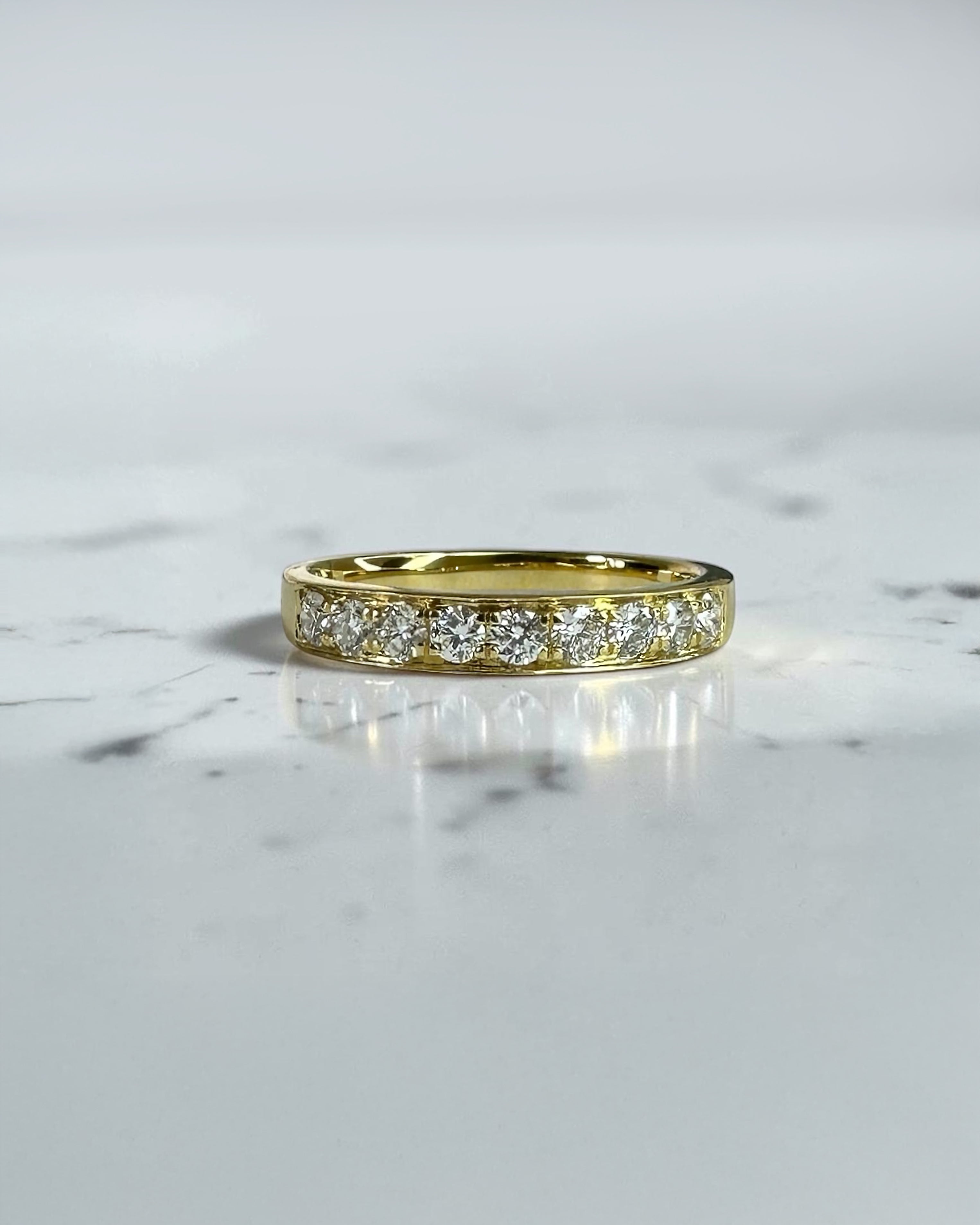 3.3mm yellow gold channel set round diamond wedding band with 0.45ct diamonds, available in lab grown or natural diamonds.