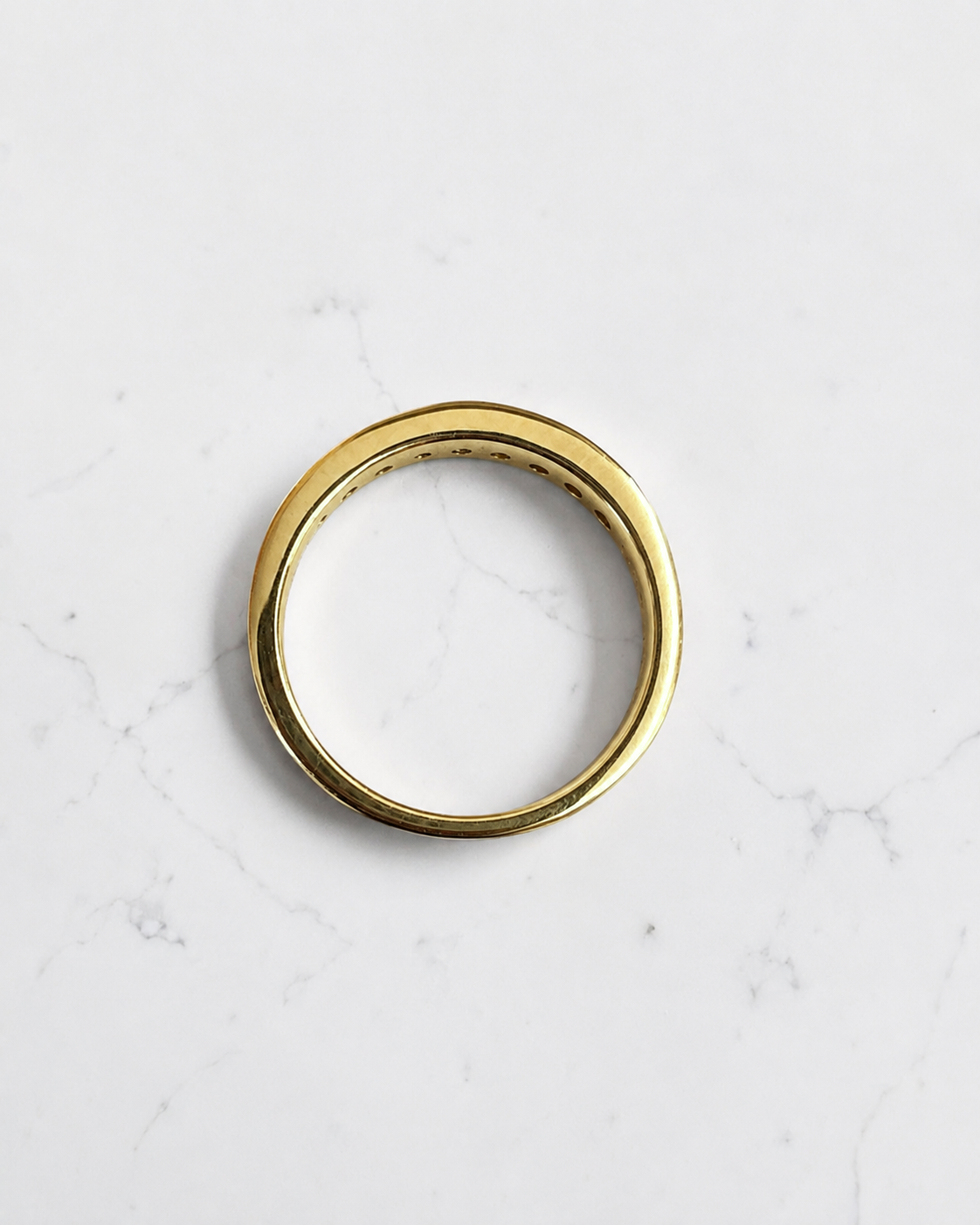 3.3mm yellow gold channel set round diamond wedding band with 0.45ct diamonds, available in lab grown or natural diamonds.