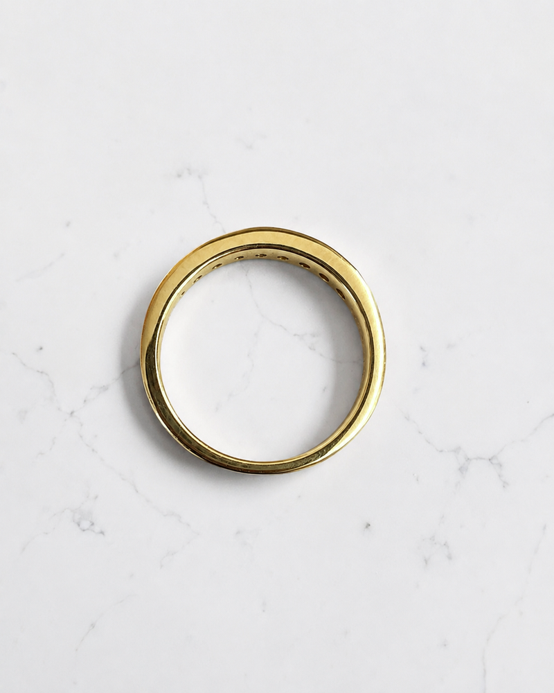 3.3mm yellow gold channel set round diamond wedding band with 0.45ct diamonds, available in lab grown or natural diamonds.