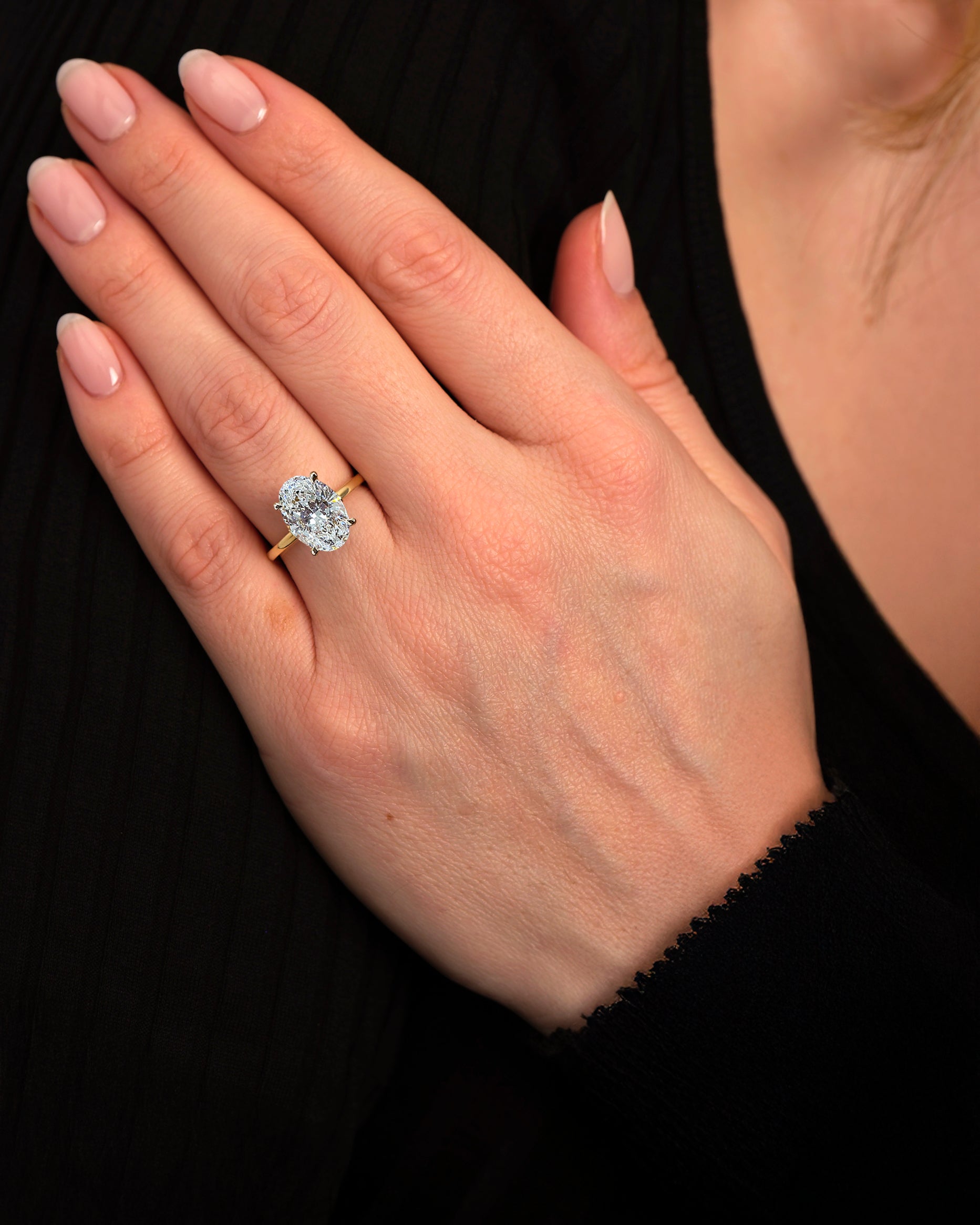 3.50ct oval cut lab grown diamond engagement ring with platinum head and hidden halo 18kt yellow gold on hand