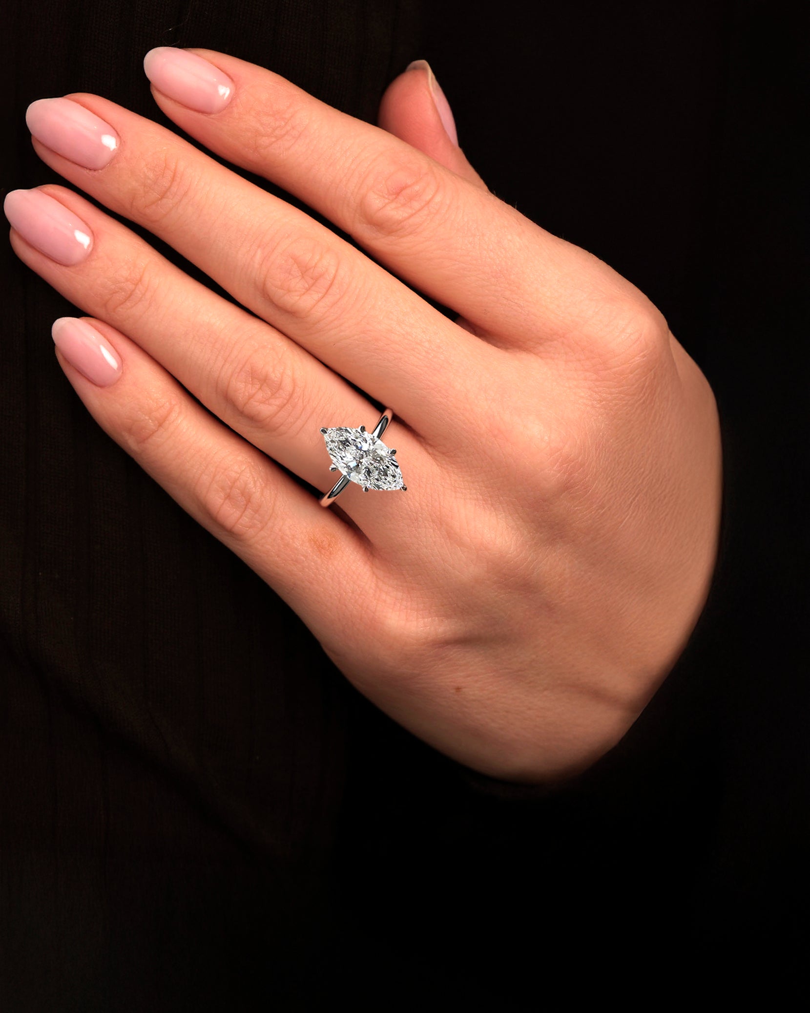 Marquise cut 3.50ct lab grown diamond engagement ring with diamond hidden halo and floating head, shown on hand in platinum band.