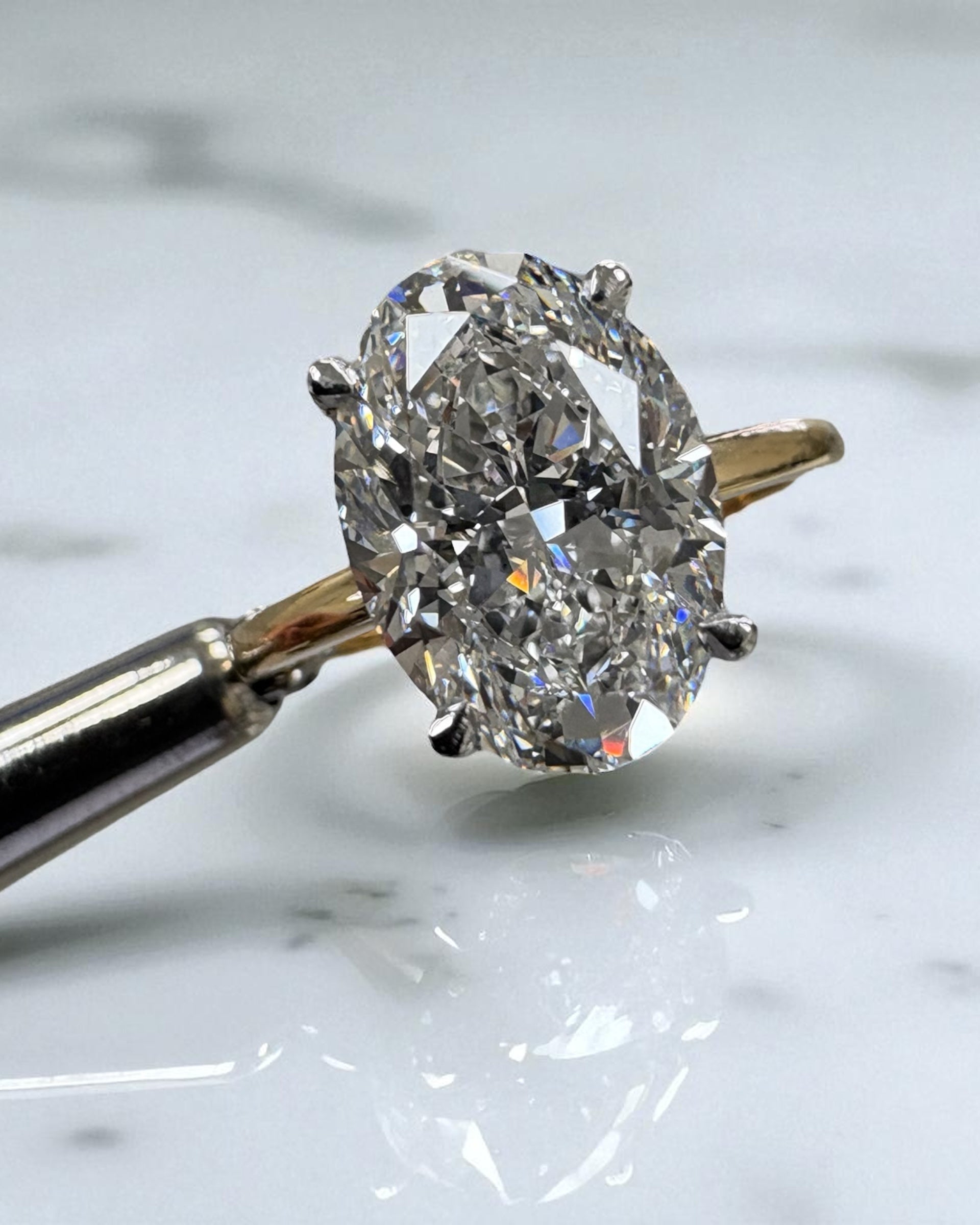 3.50ct oval cut lab grown diamond engagement ring with platinum head and hidden halo 18kt yellow gold