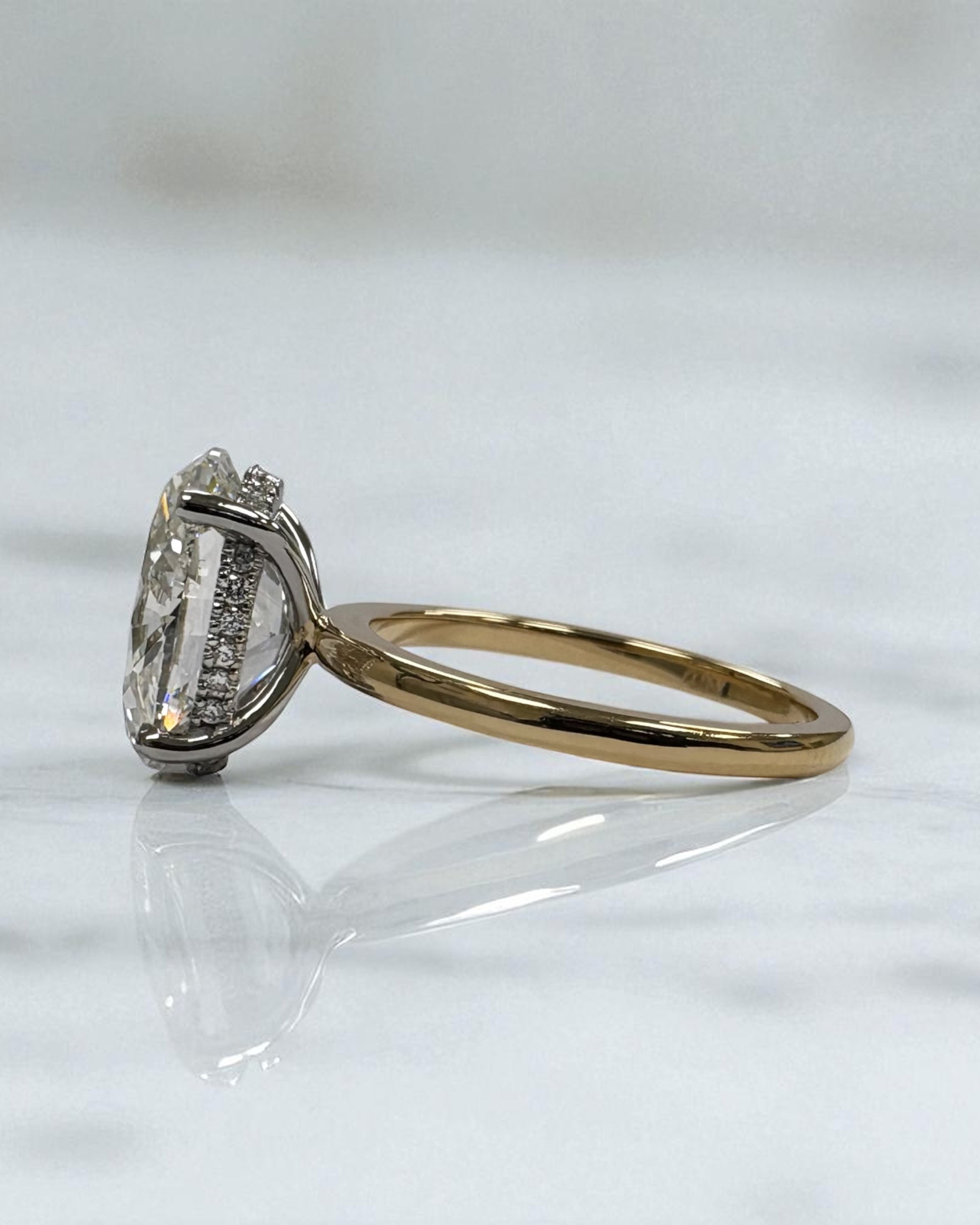 3.50ct oval cut lab grown diamond engagement ring with platinum head and hidden halo 18kt yellow gold