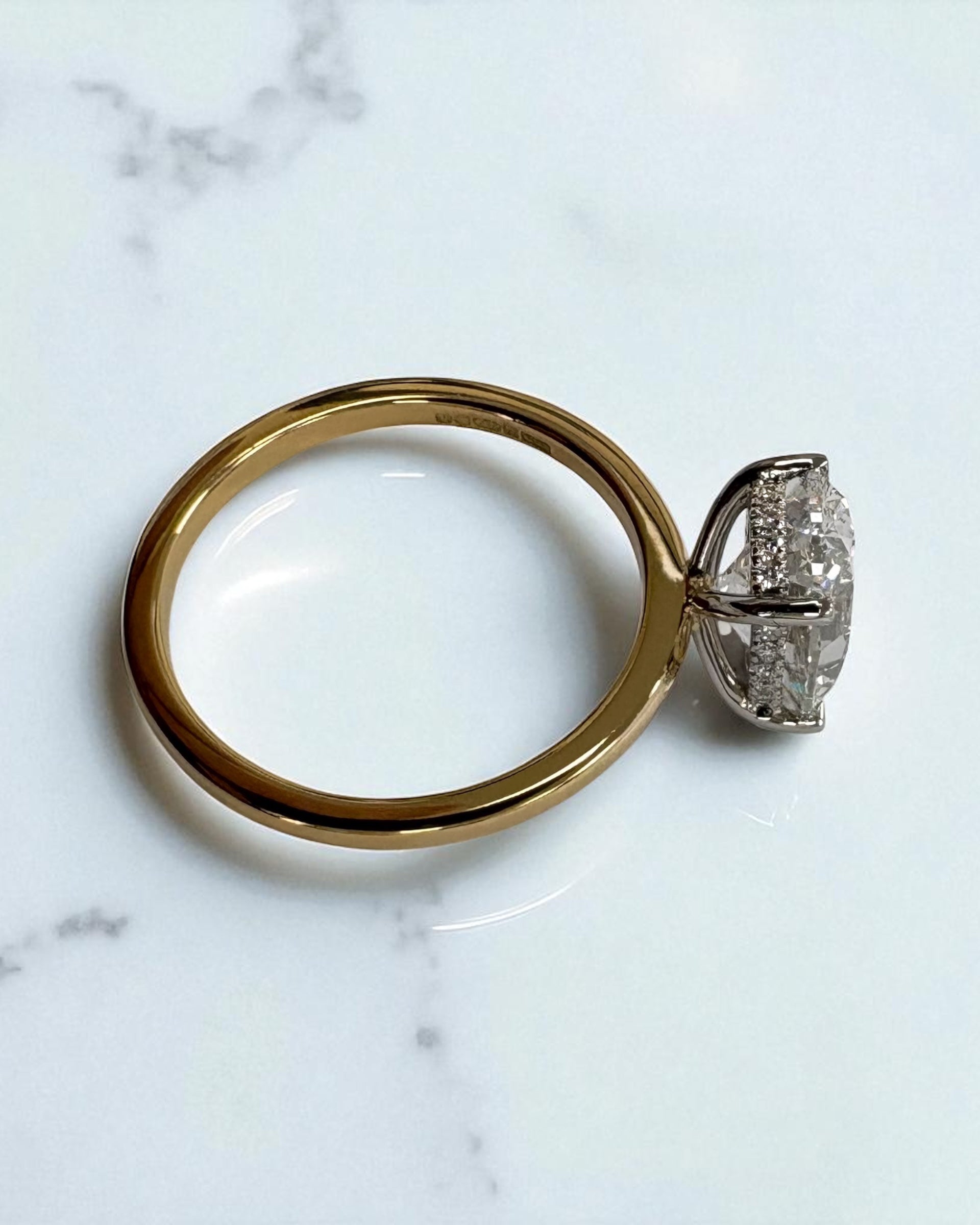 3.50ct oval cut lab grown diamond engagement ring with platinum head and hidden halo 18kt yellow gold