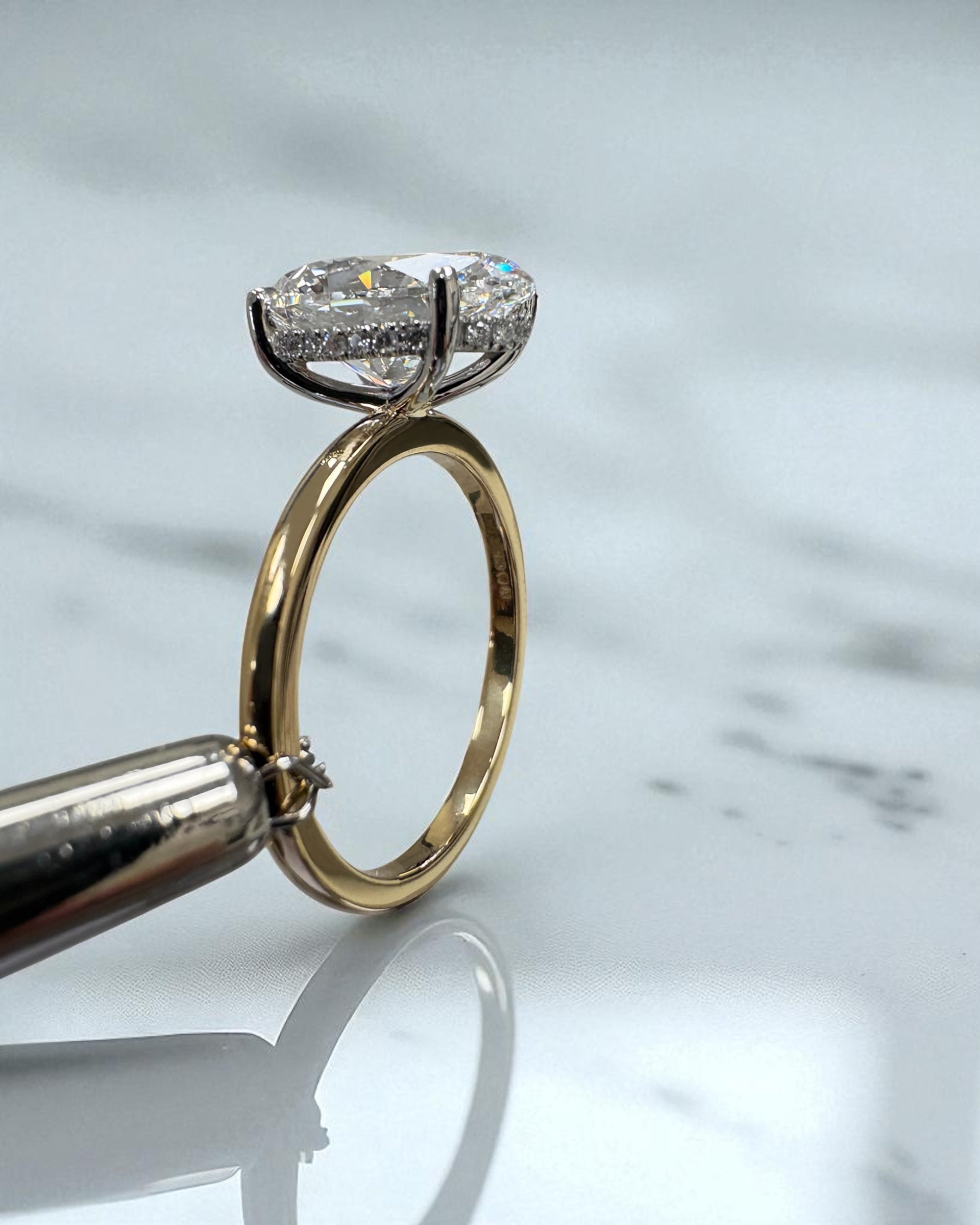 3.50ct oval cut lab grown diamond engagement ring with platinum head and hidden halo 18kt yellow gold