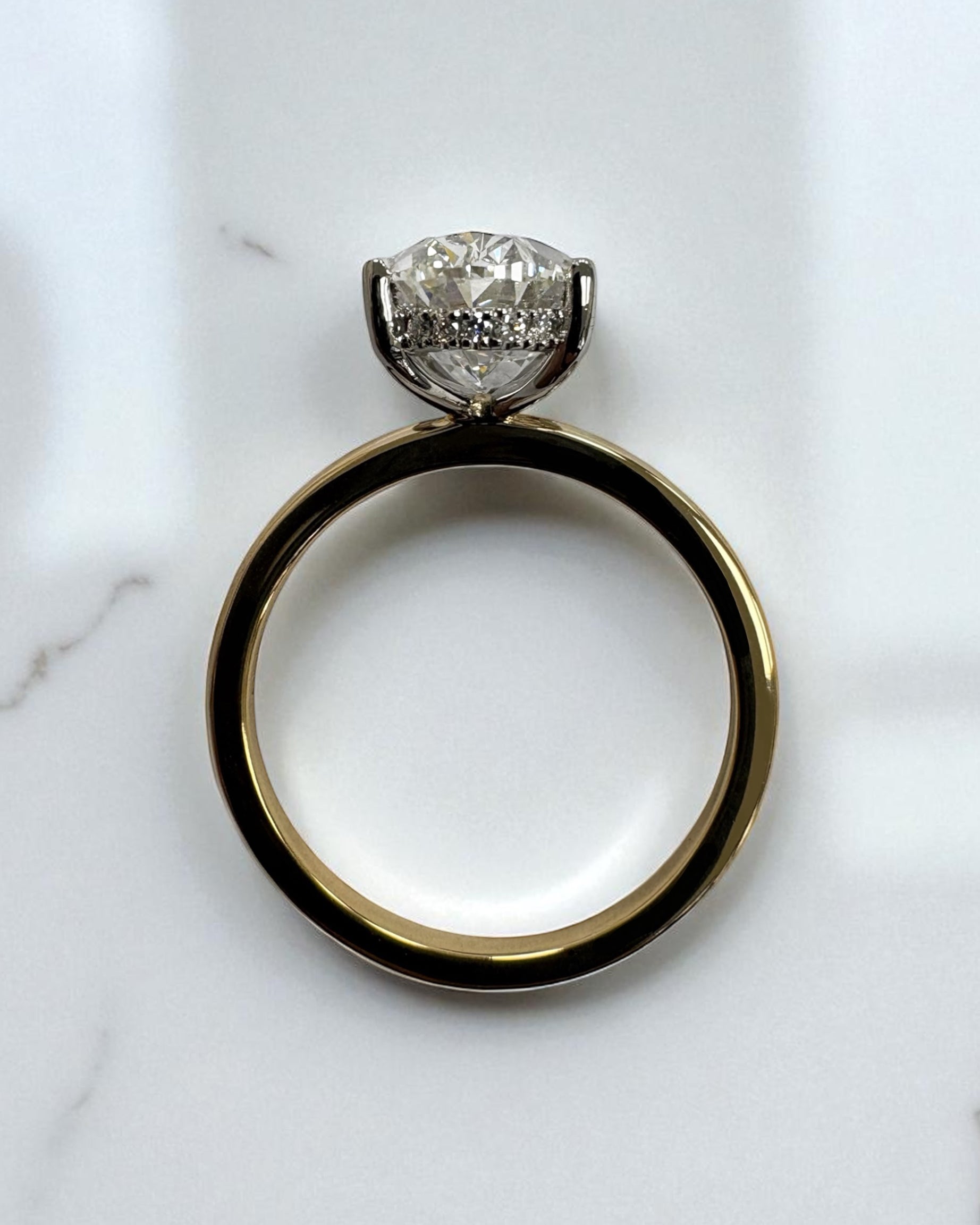 3.50ct oval cut lab grown diamond engagement ring with platinum head and hidden halo 18kt yellow gold