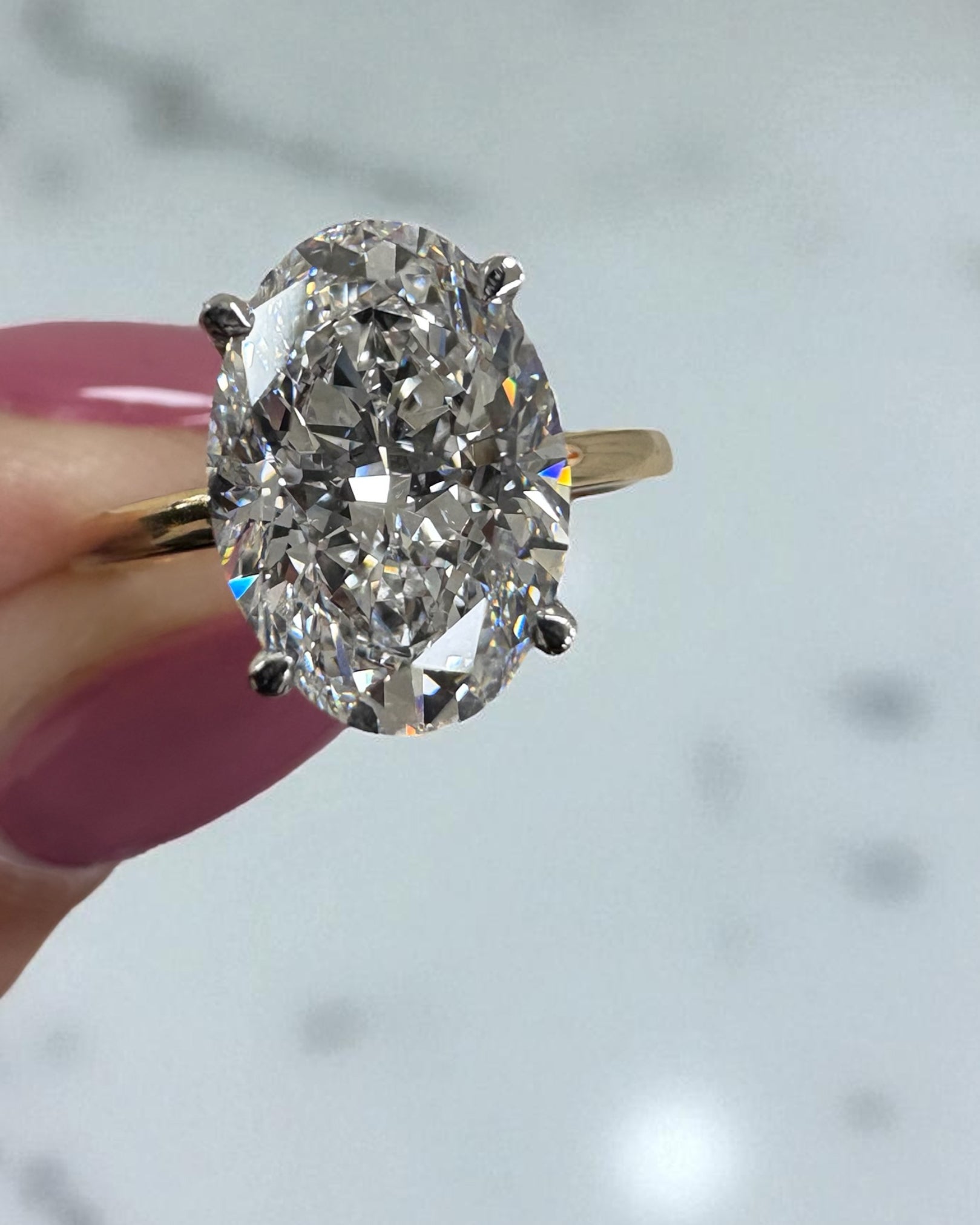 3.50ct oval cut lab grown diamond engagement ring with platinum head and hidden halo 18kt yellow gold
