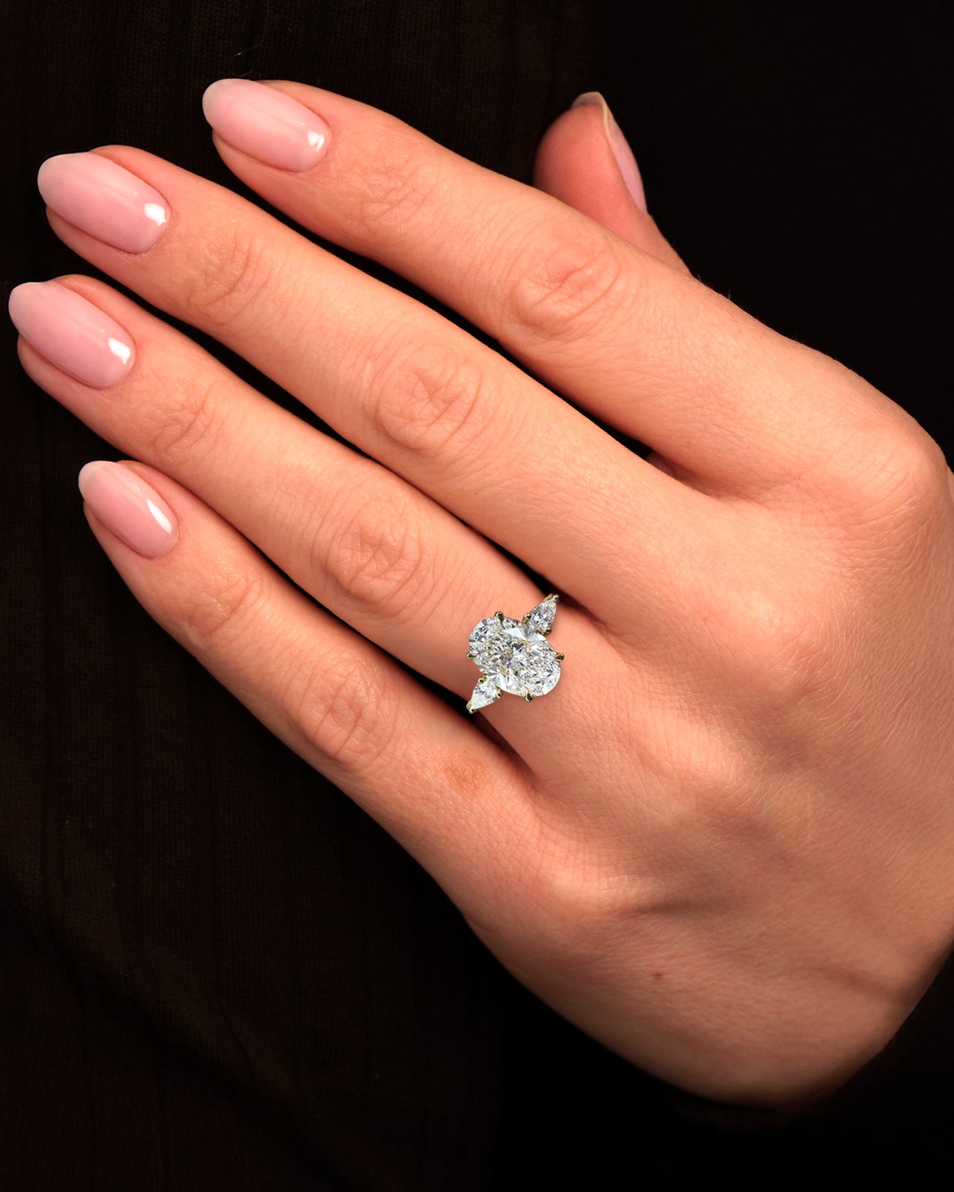 3.50ct Oval Cut Lab grown diamonds with Pear cut diamond trilogy engagement ring 18kt yellow gold on hand 