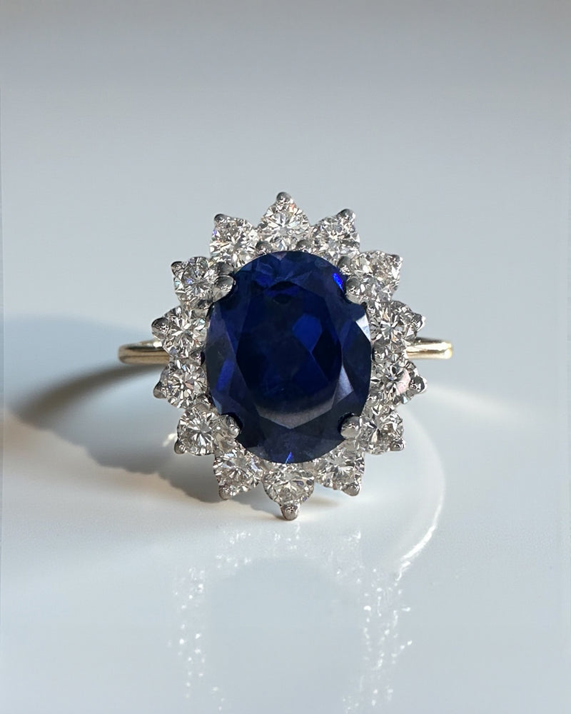 3ct oval cut lab grown blue sapphire halo diamond ring with 0.80ct diamonds. Crafted in 9kt or 18kt gold or platinum. British hallmarked.
