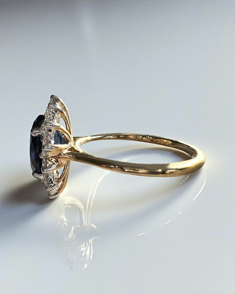 3ct oval cut lab grown blue sapphire halo diamond ring with 0.80ct diamonds. Crafted in 9kt or 18kt gold or platinum. British hallmarked.
