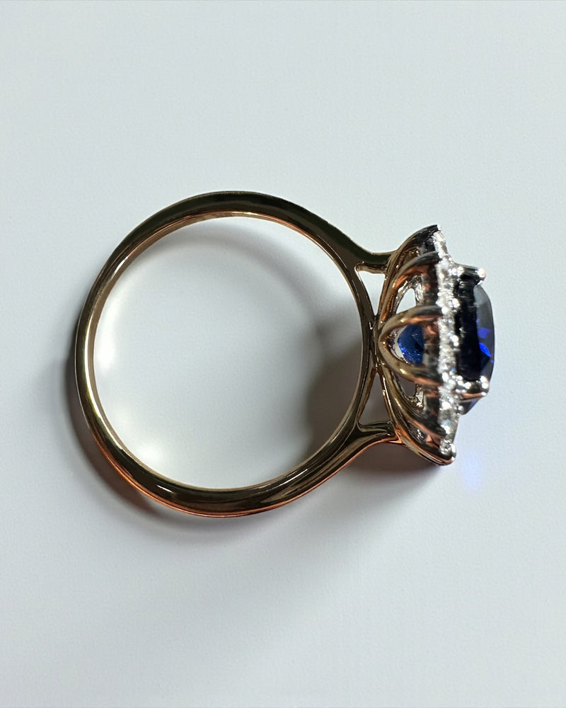 3ct oval cut lab grown blue sapphire halo diamond ring with 0.80ct diamonds. Crafted in 9kt or 18kt gold or platinum. British hallmarked.

